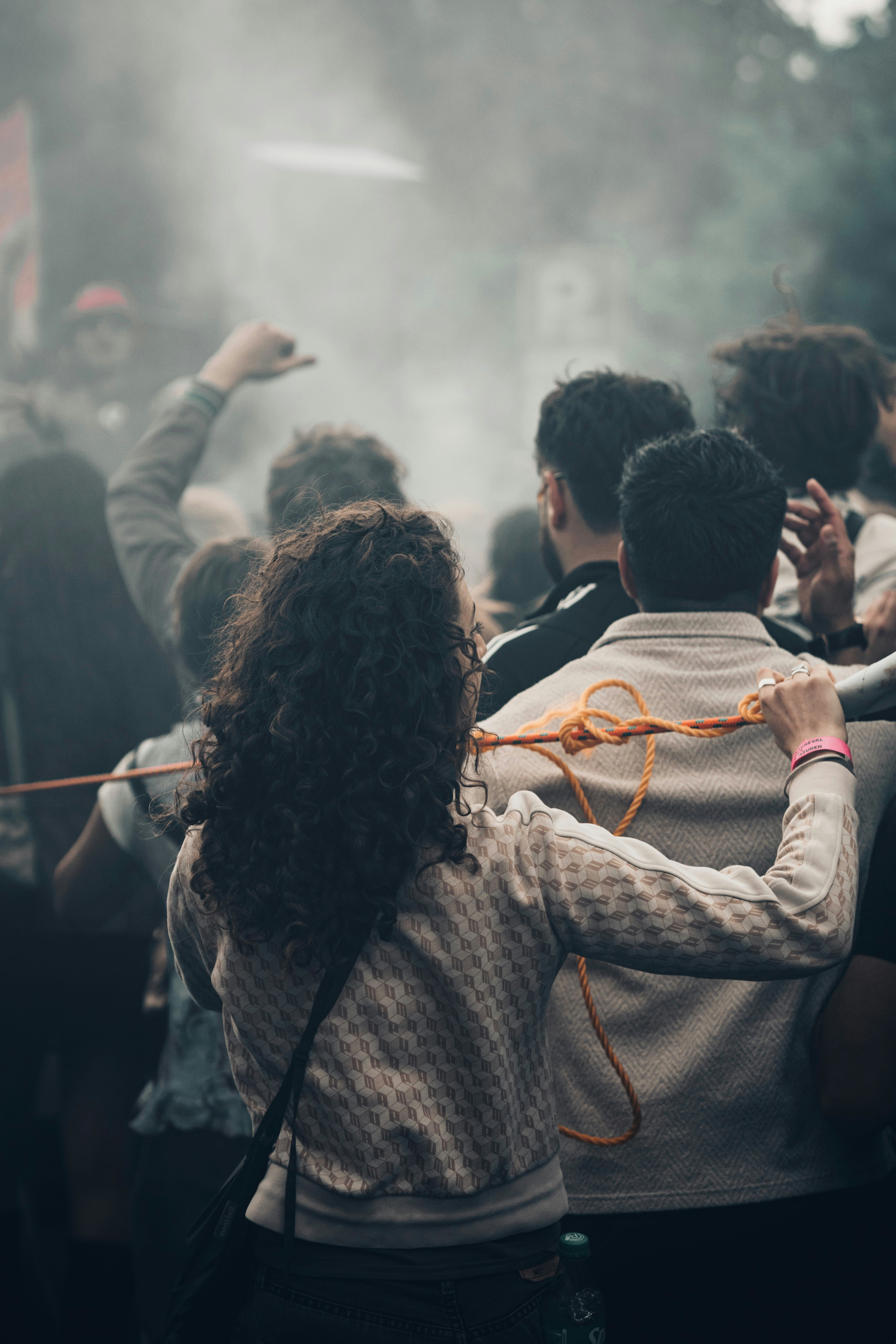 Crowd with orange rope in hazy atmosphere