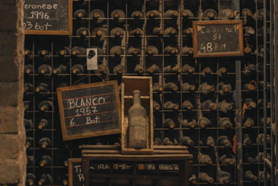 Bottles and chalkboard vintage markers in a Mendoza bodega cellar
