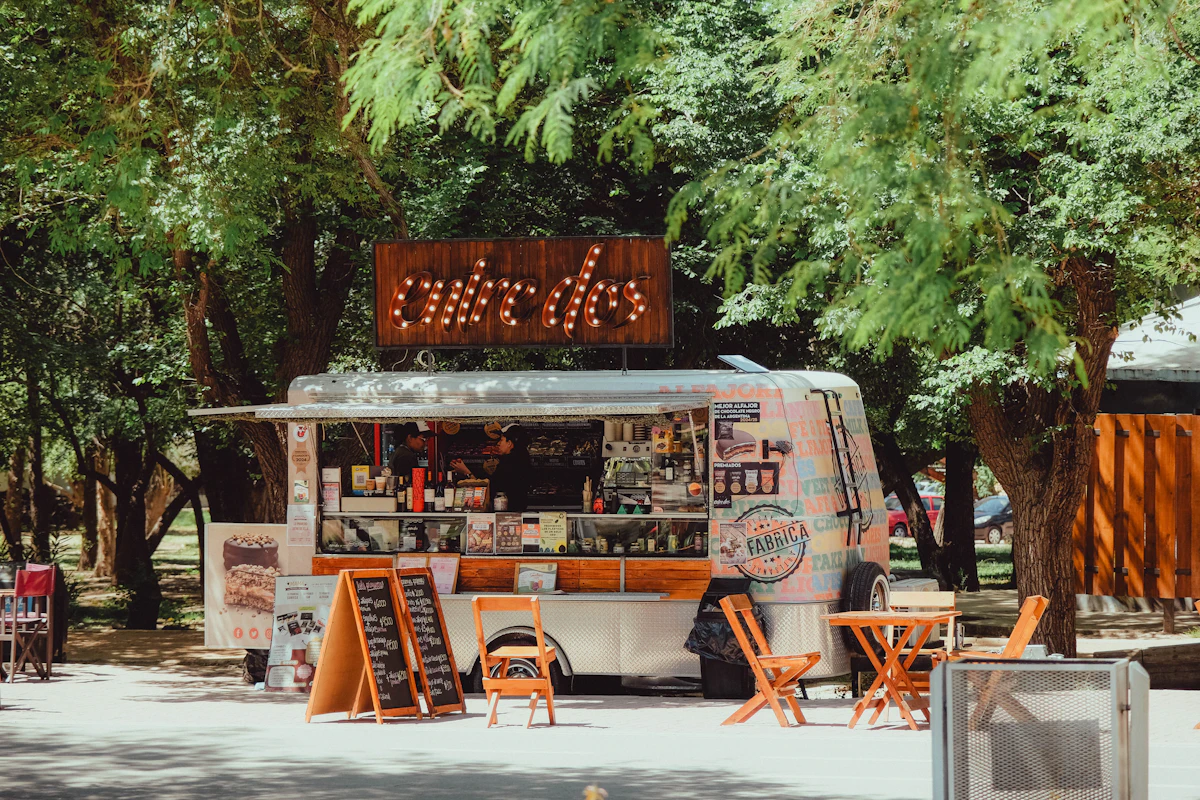 Food truck with outdoor seating under the trees