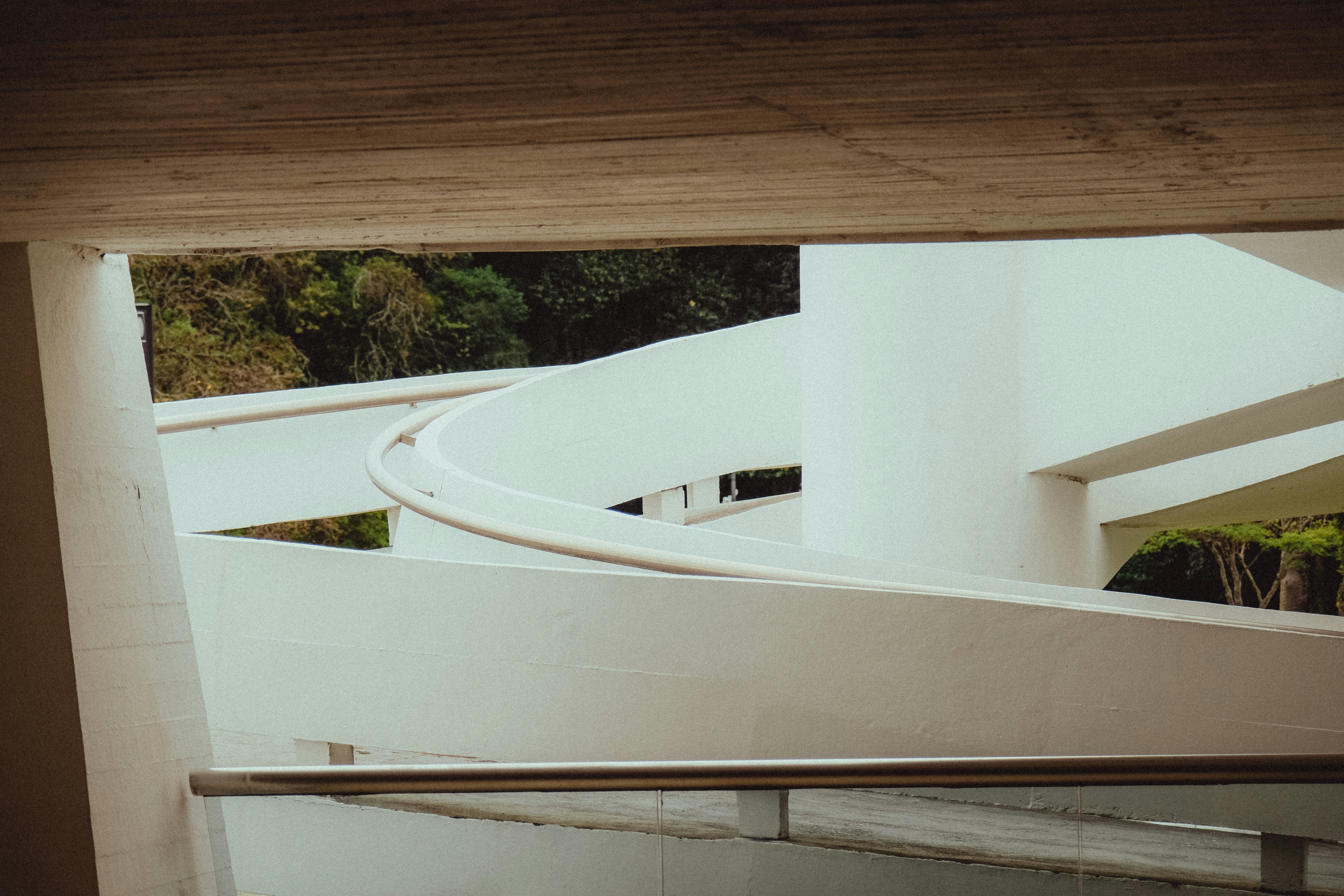 White spiral ramp with greenery in the background