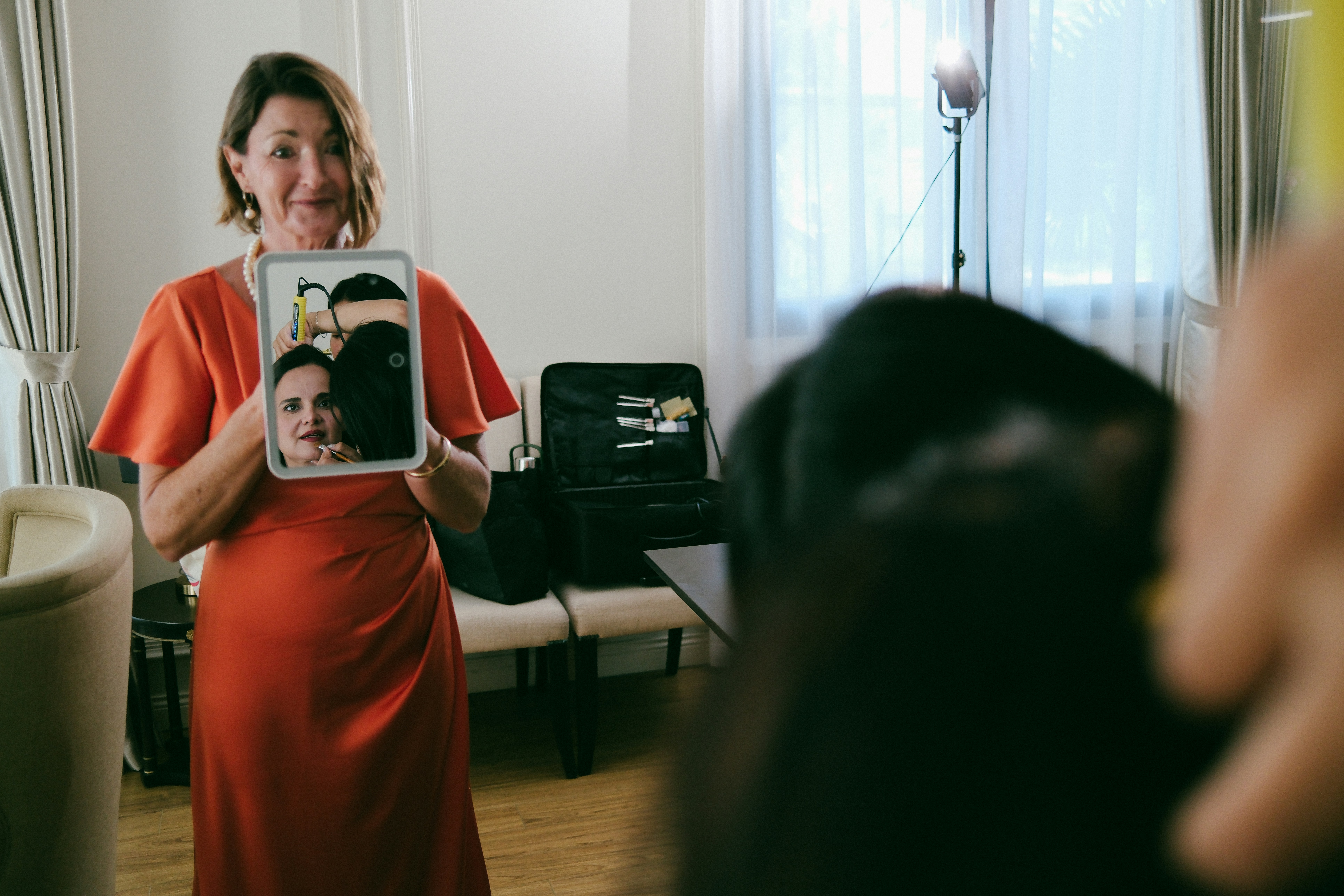 Woman holds tablet showing faces of a couple