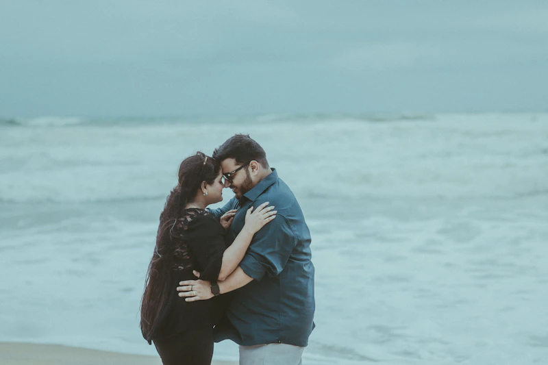 STD-aware couple embracing on a beach