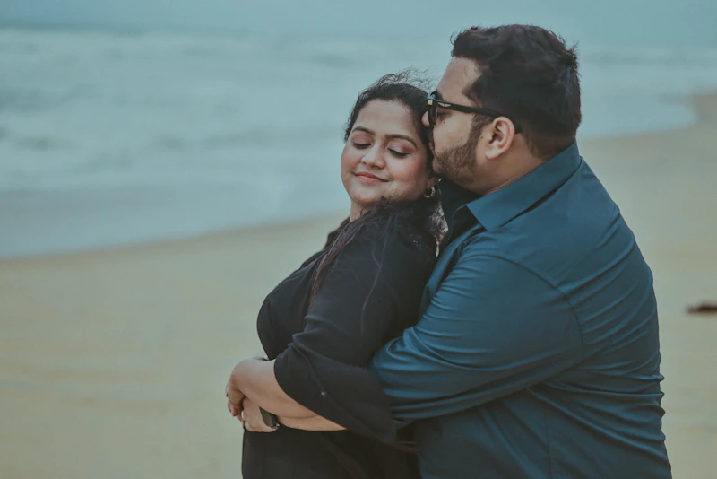 Couple embracing on a beach near ocean