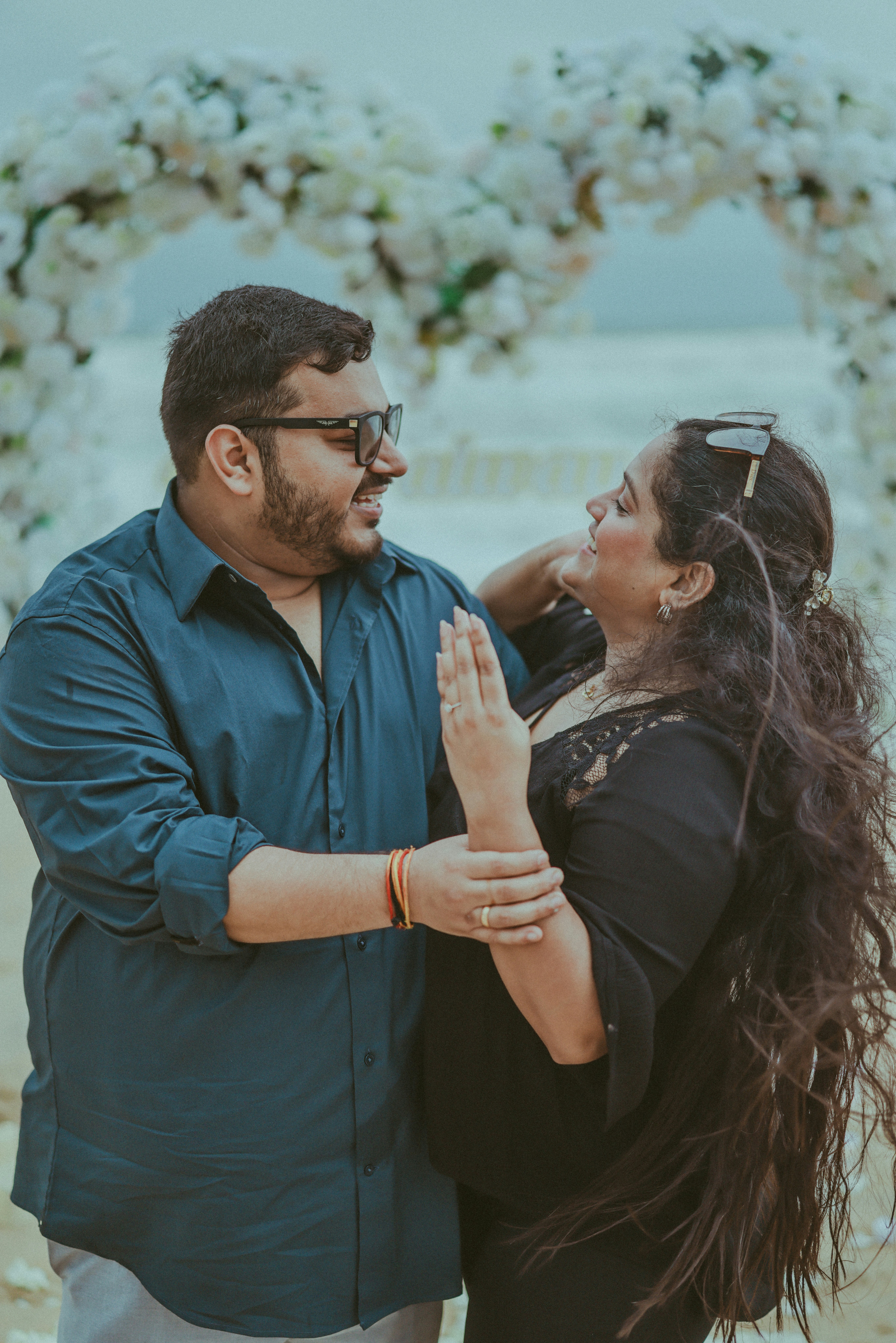 Couple smiling at each other on a beach