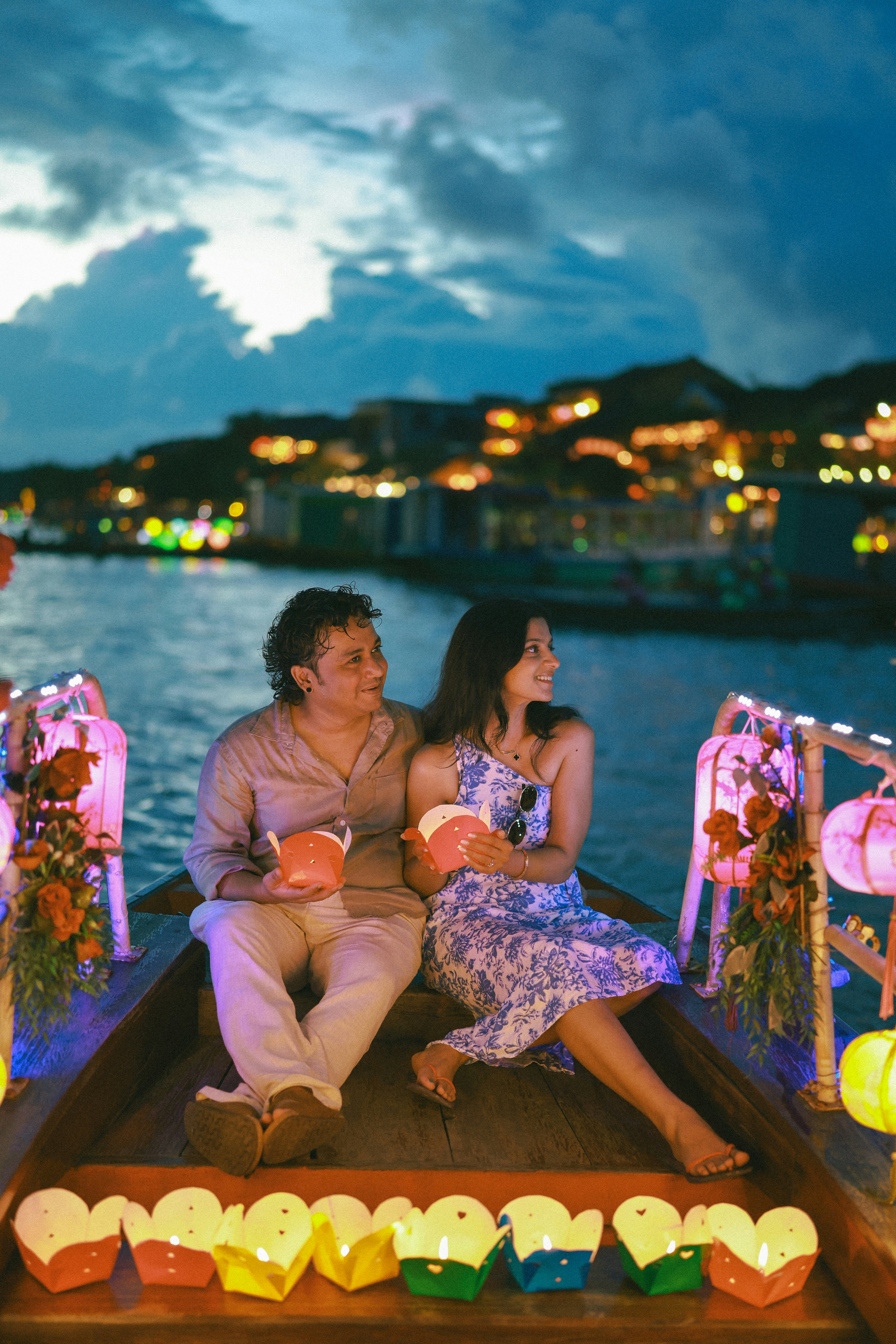 Couple on boat with lanterns at night