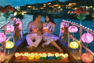 Couple on a boat with lanterns at night
