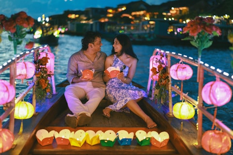 Couple on a boat with lanterns at night
