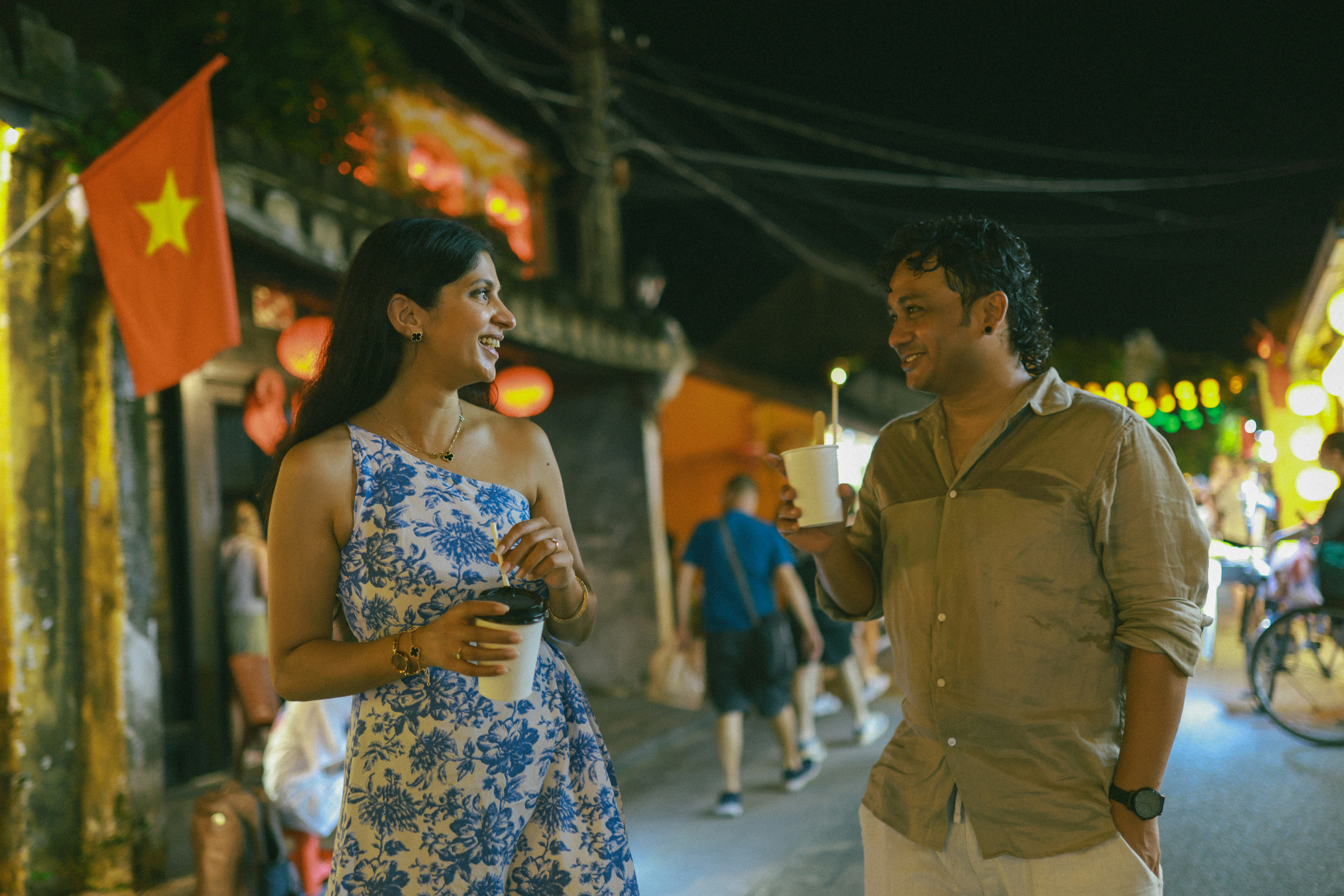 Couple walking down a street at night