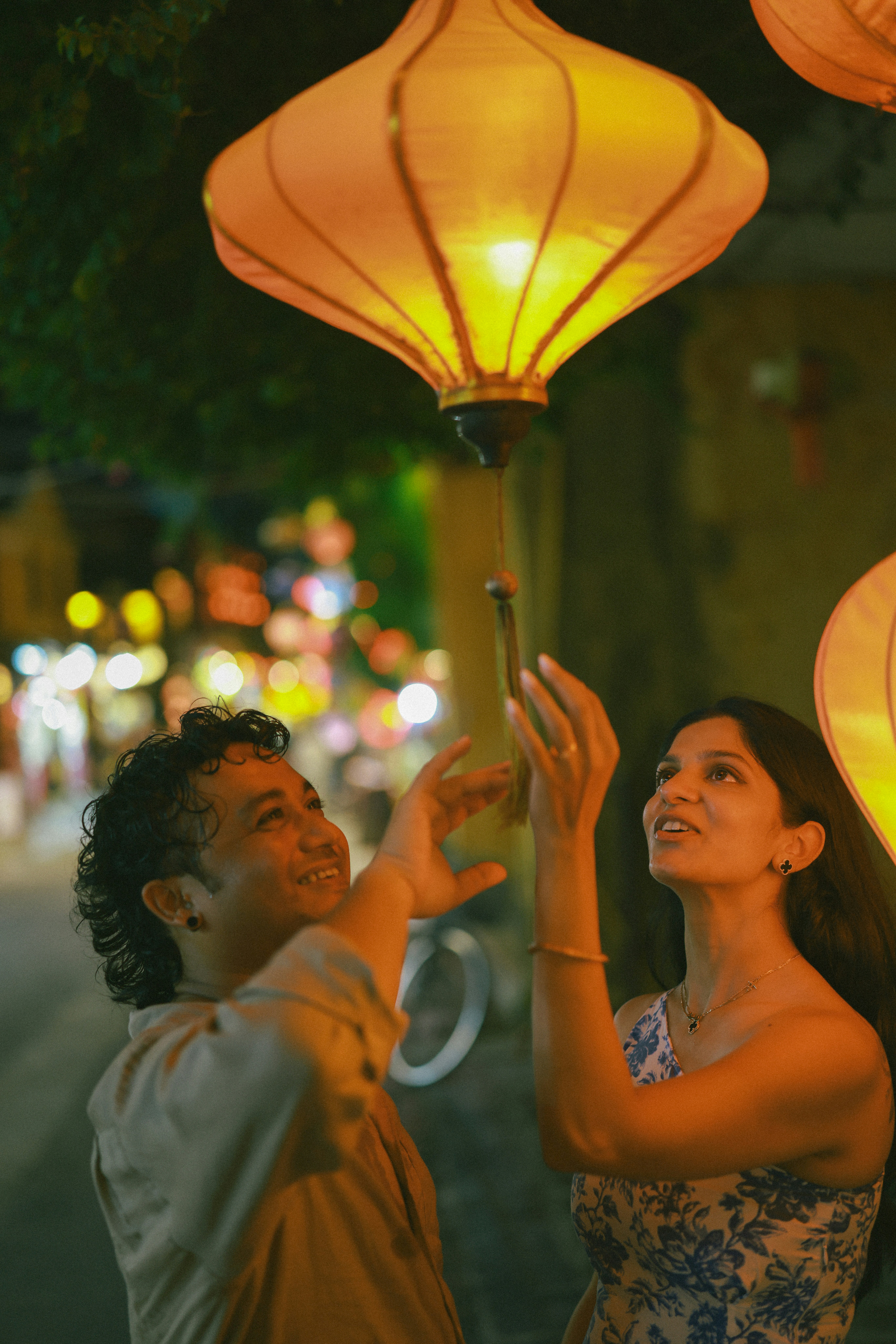 Couple reaching for illuminated lanterns at night photo – Free Travel ...