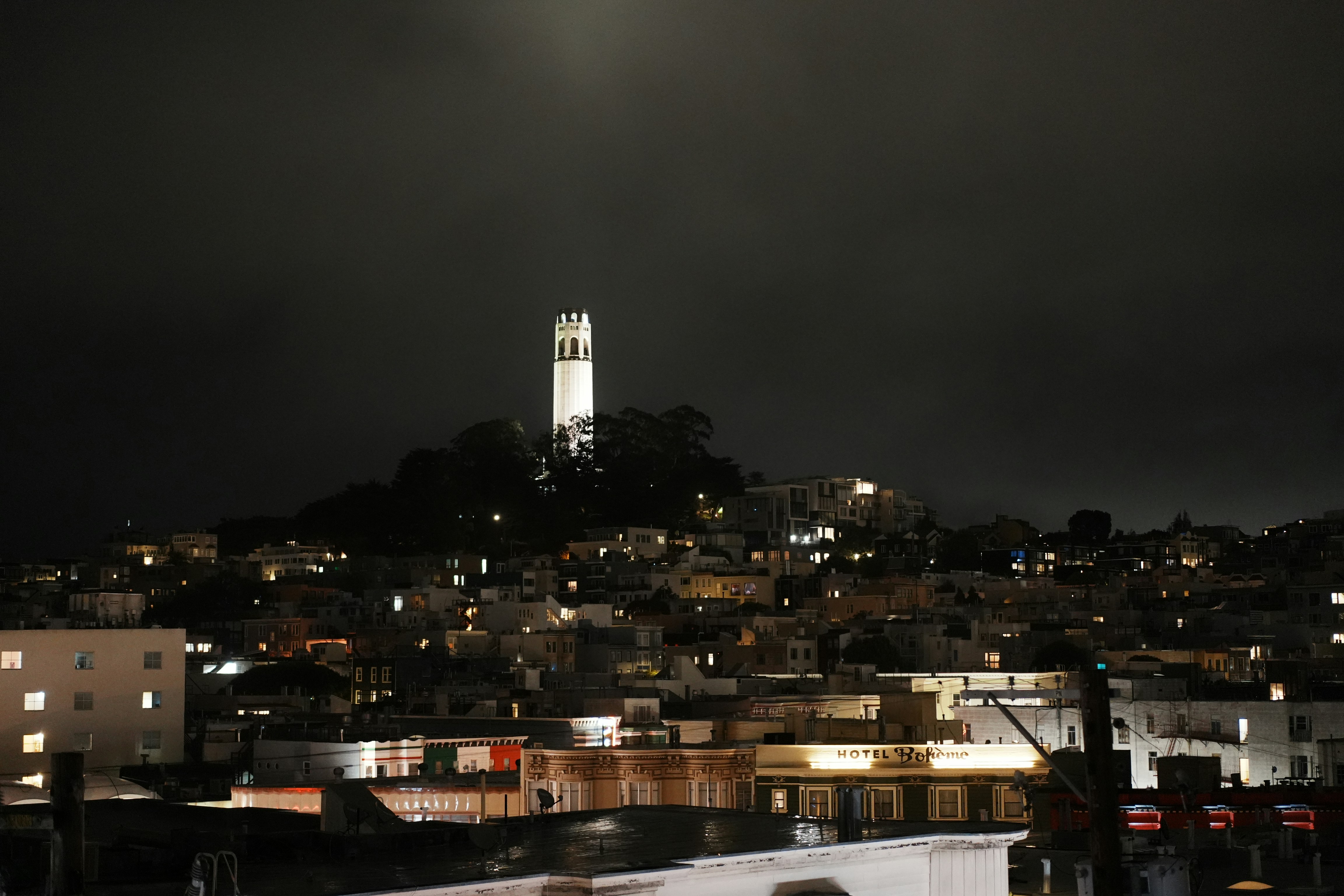 City skyline with illuminated tower at night