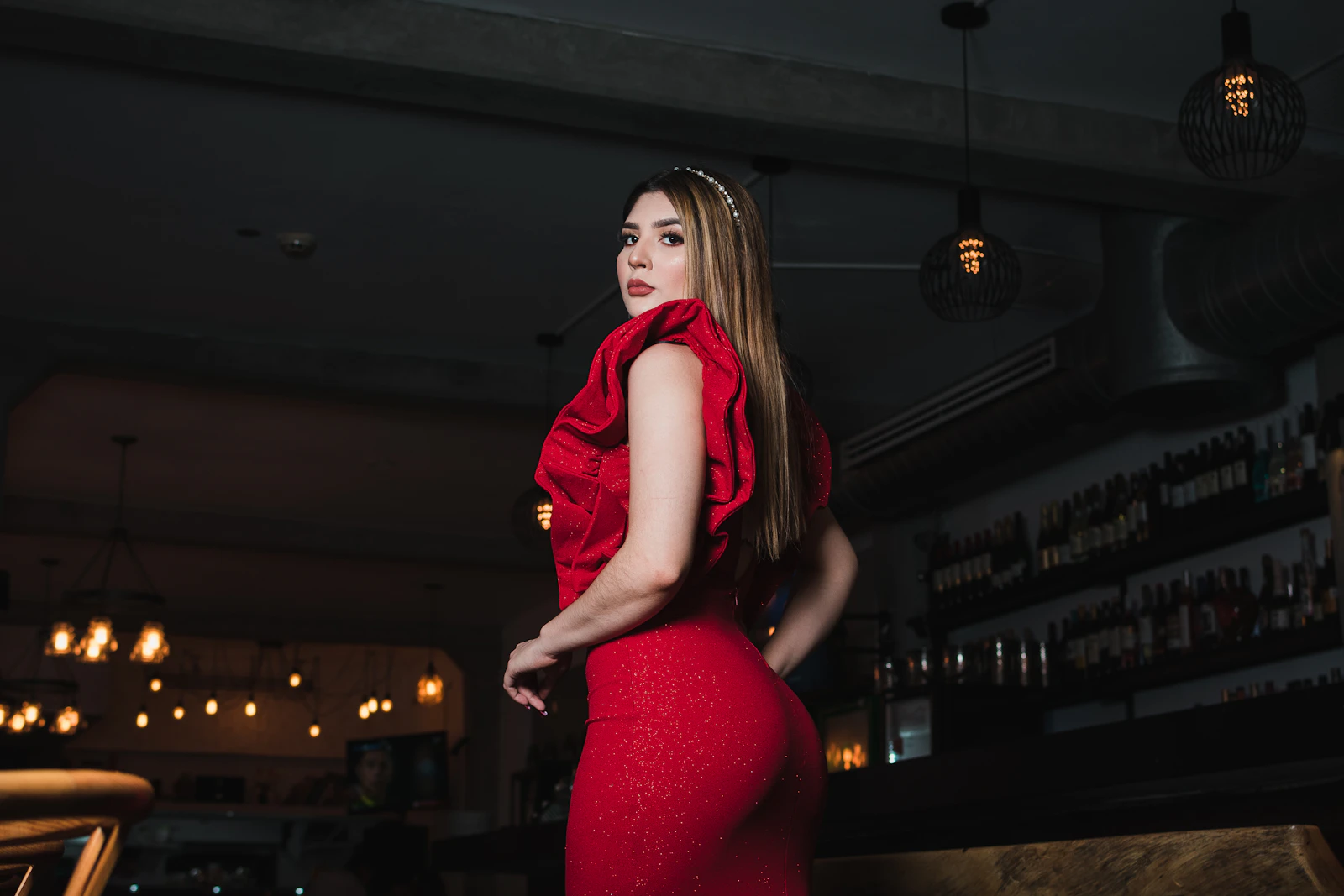 Woman in a sparkling red ruffled evening gown
