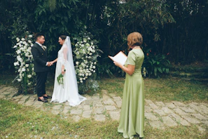 Couple exchanging vows at an outdoor wedding ceremony.
