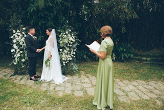 Couple exchanging vows at an outdoor wedding ceremony.