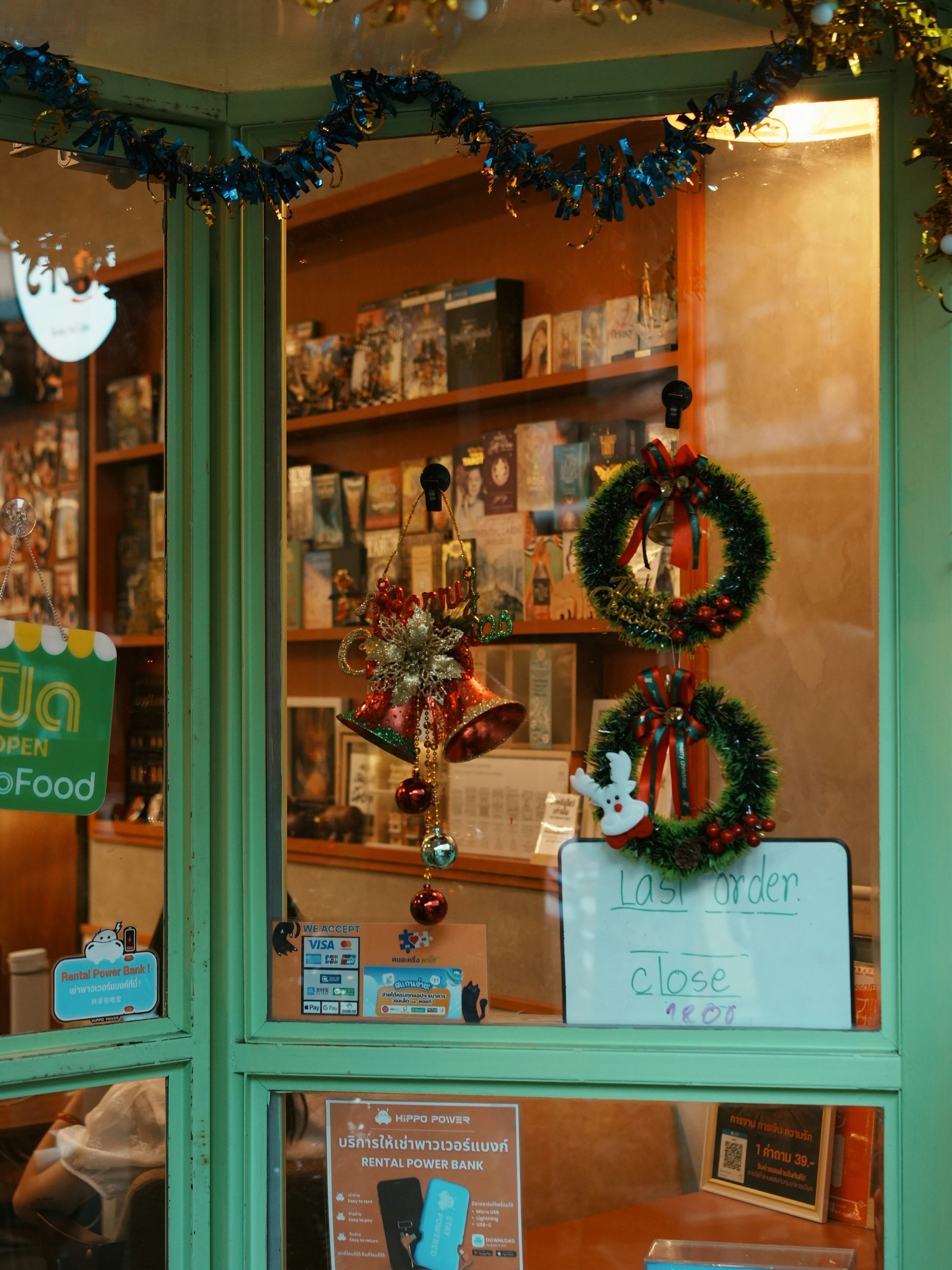 Christmas decorations adorn a shop window.