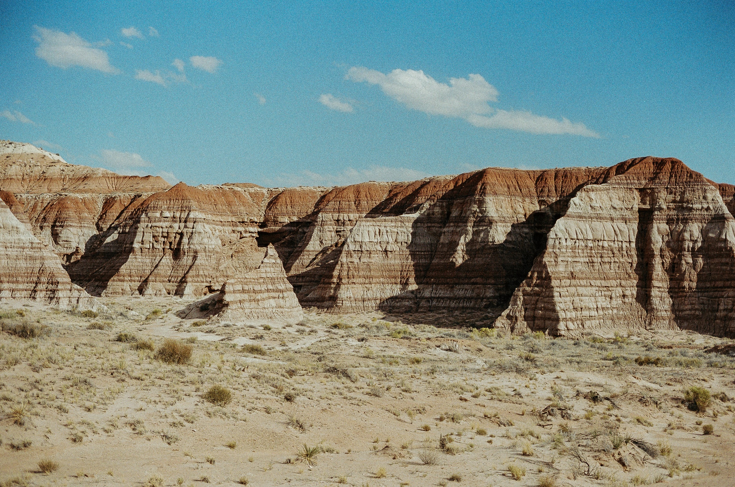 Layered sandstone cliffs under a clear blue sky