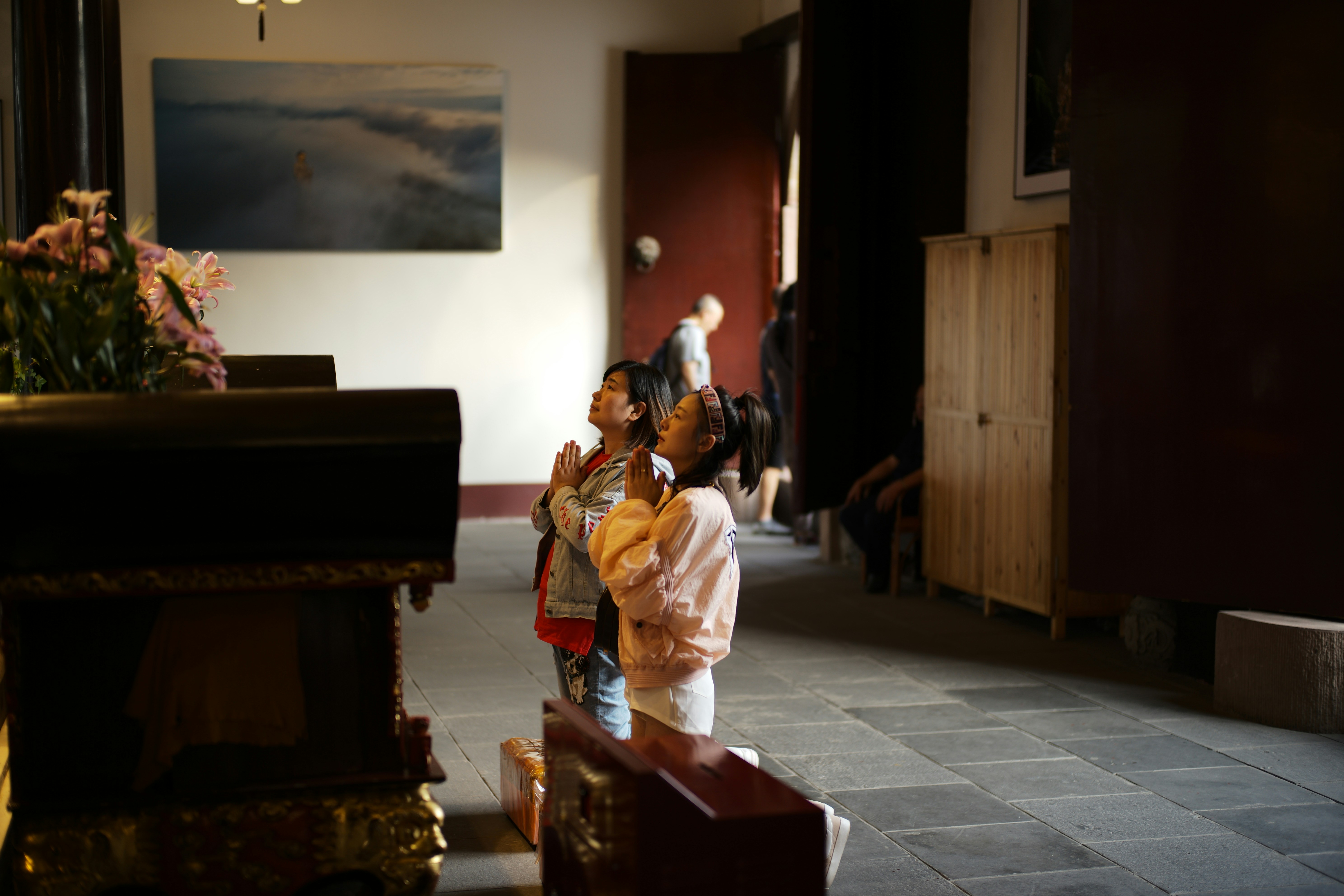 Two children looking up in a dimly lit room.