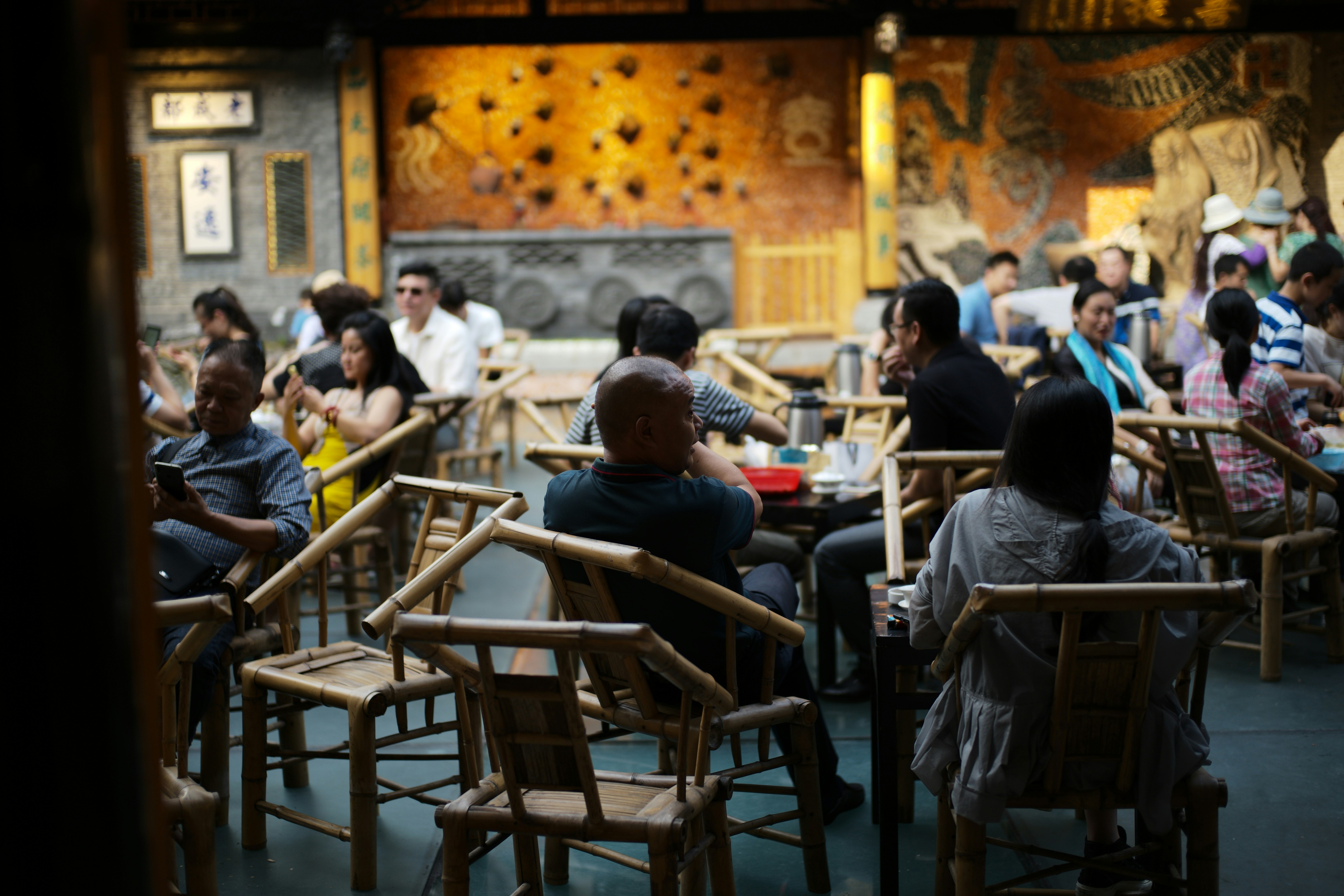 People dining in a dimly lit, ornate restaurant.