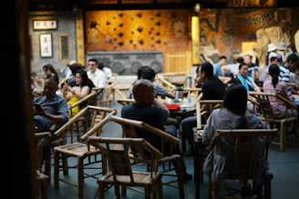 People dining in a dimly lit, ornate restaurant.