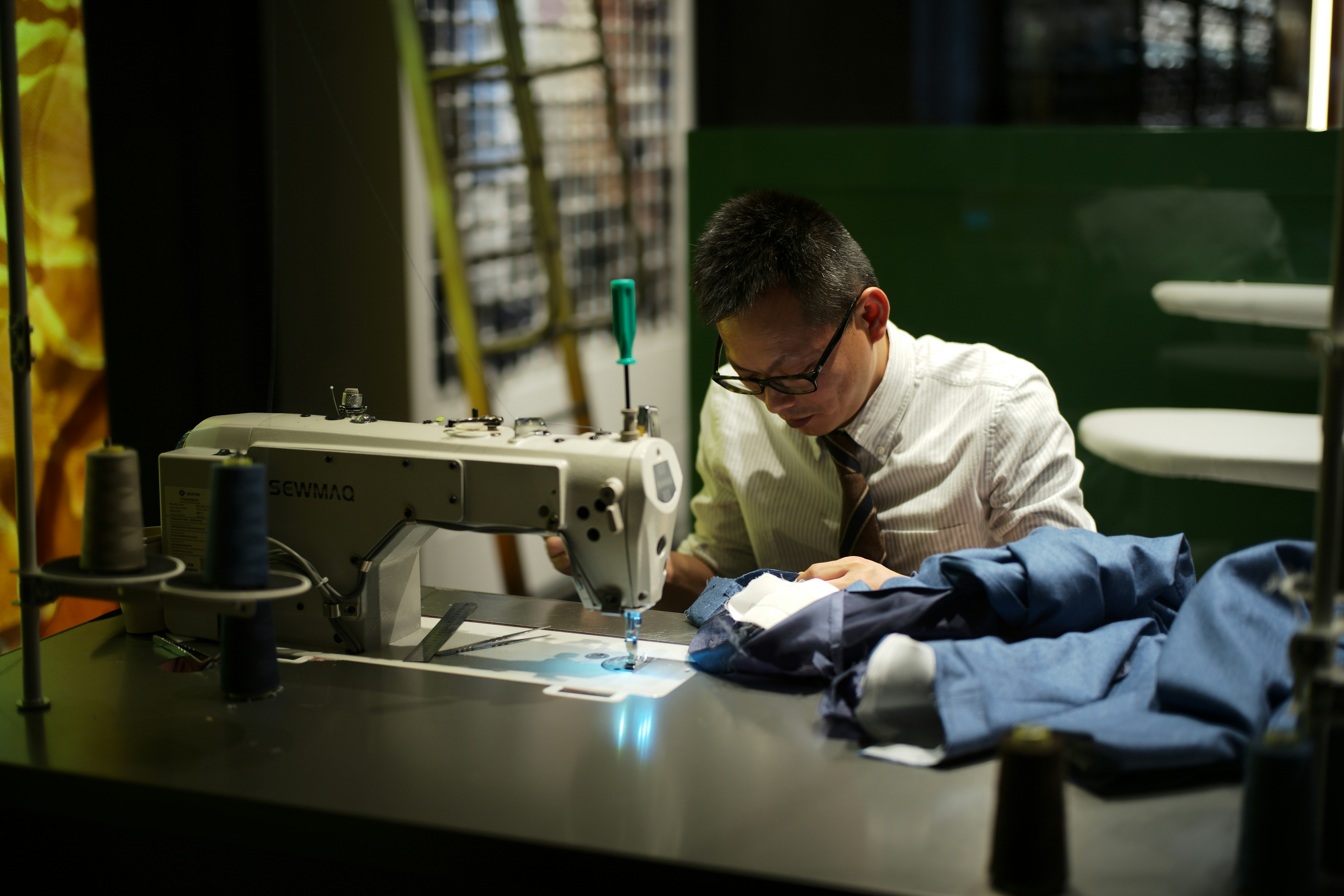 Man sewing clothes at a machine