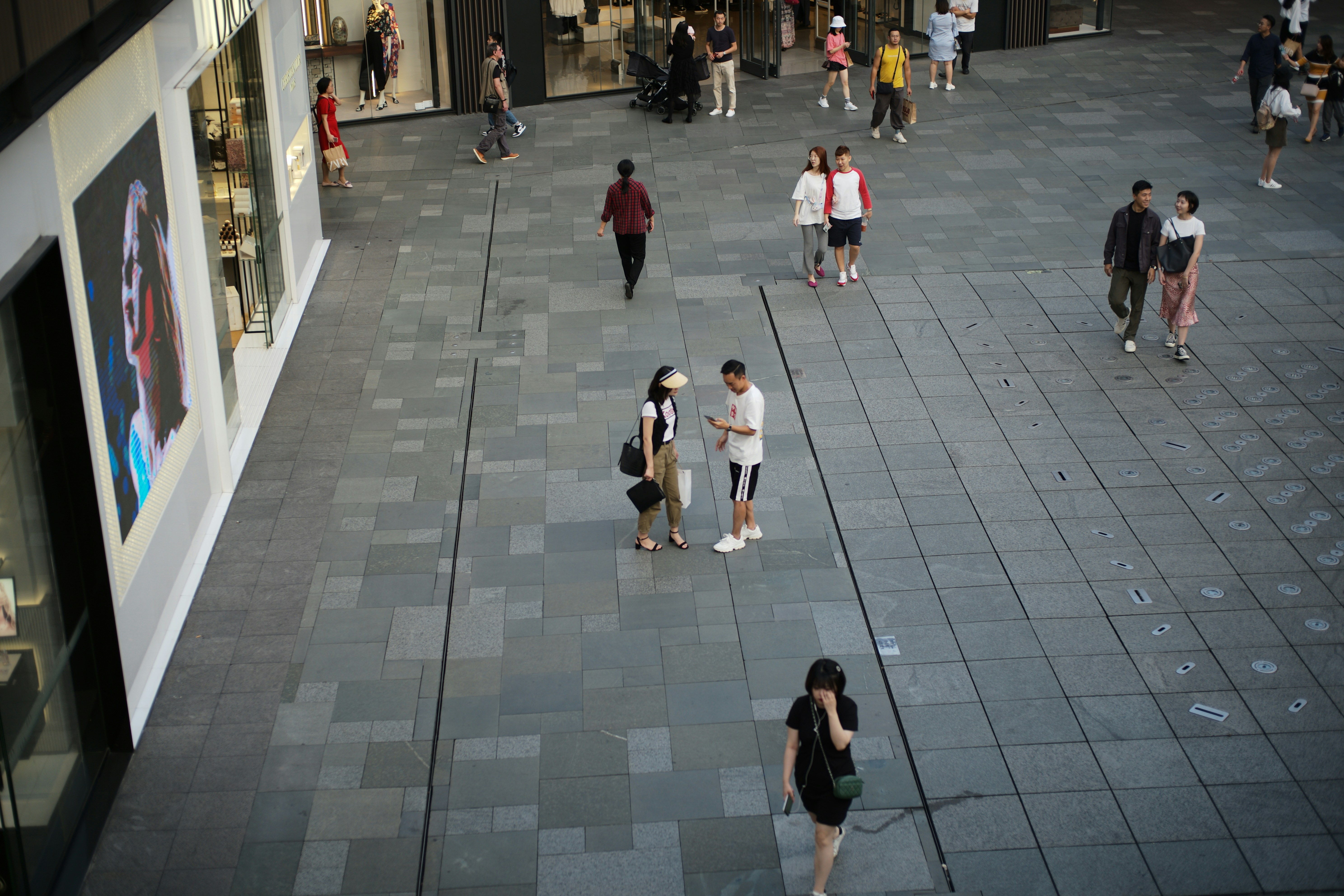 People walking on a modern city plaza