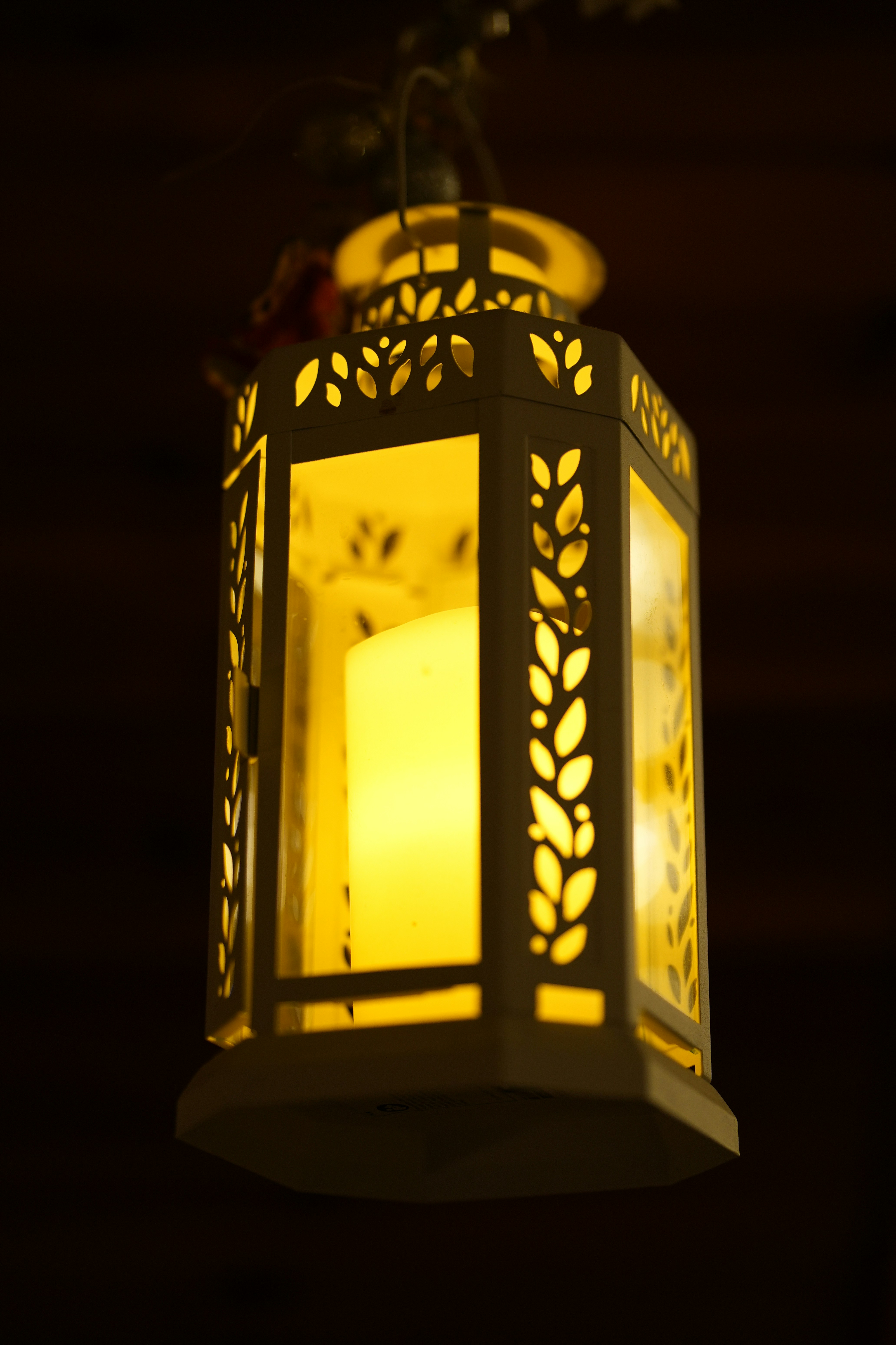 A lit lantern with a candle inside.