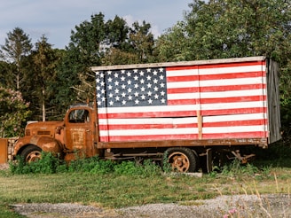 Rusty truck with american flag painted on side