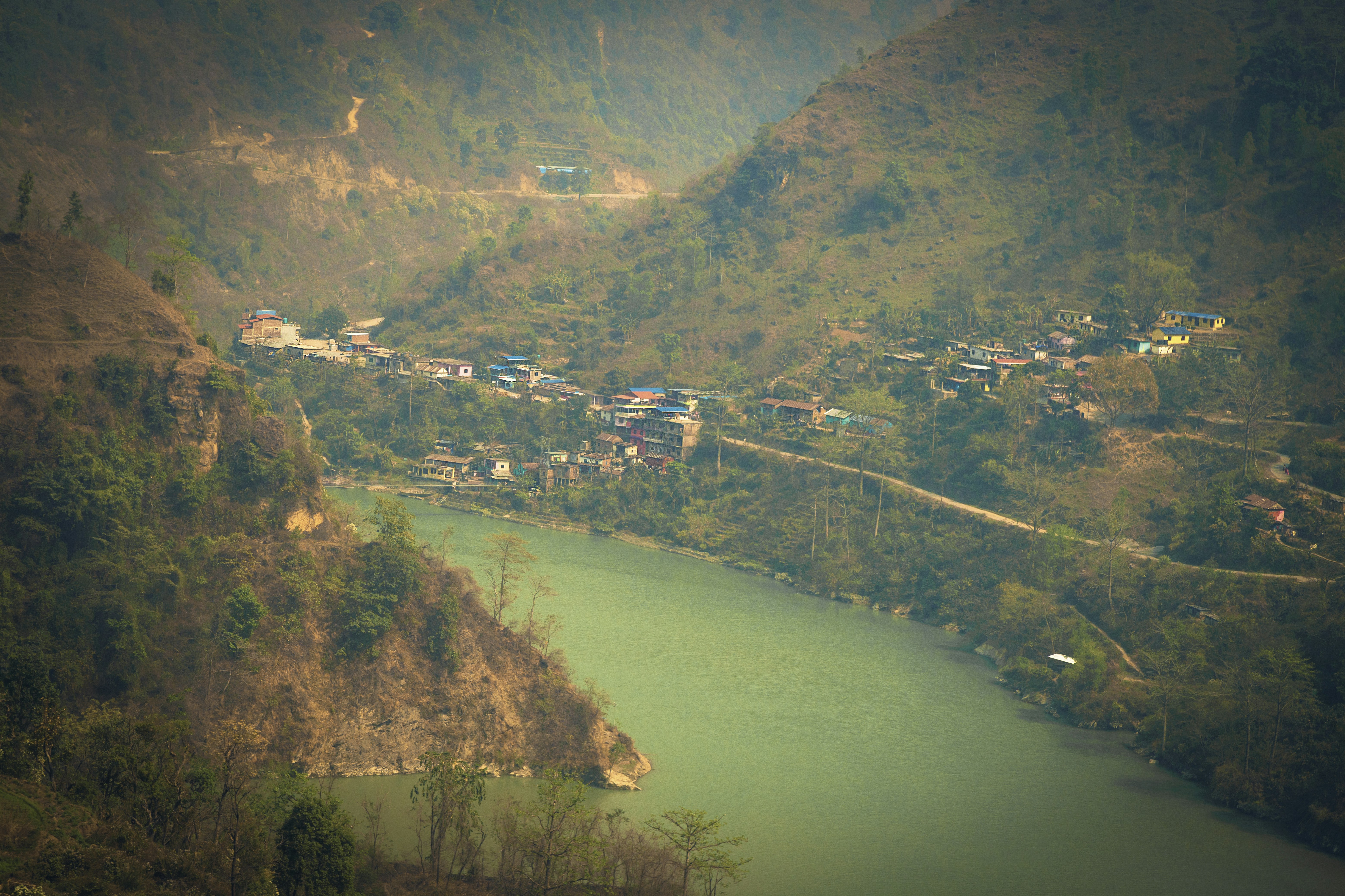 River flows through a valley with a small town.