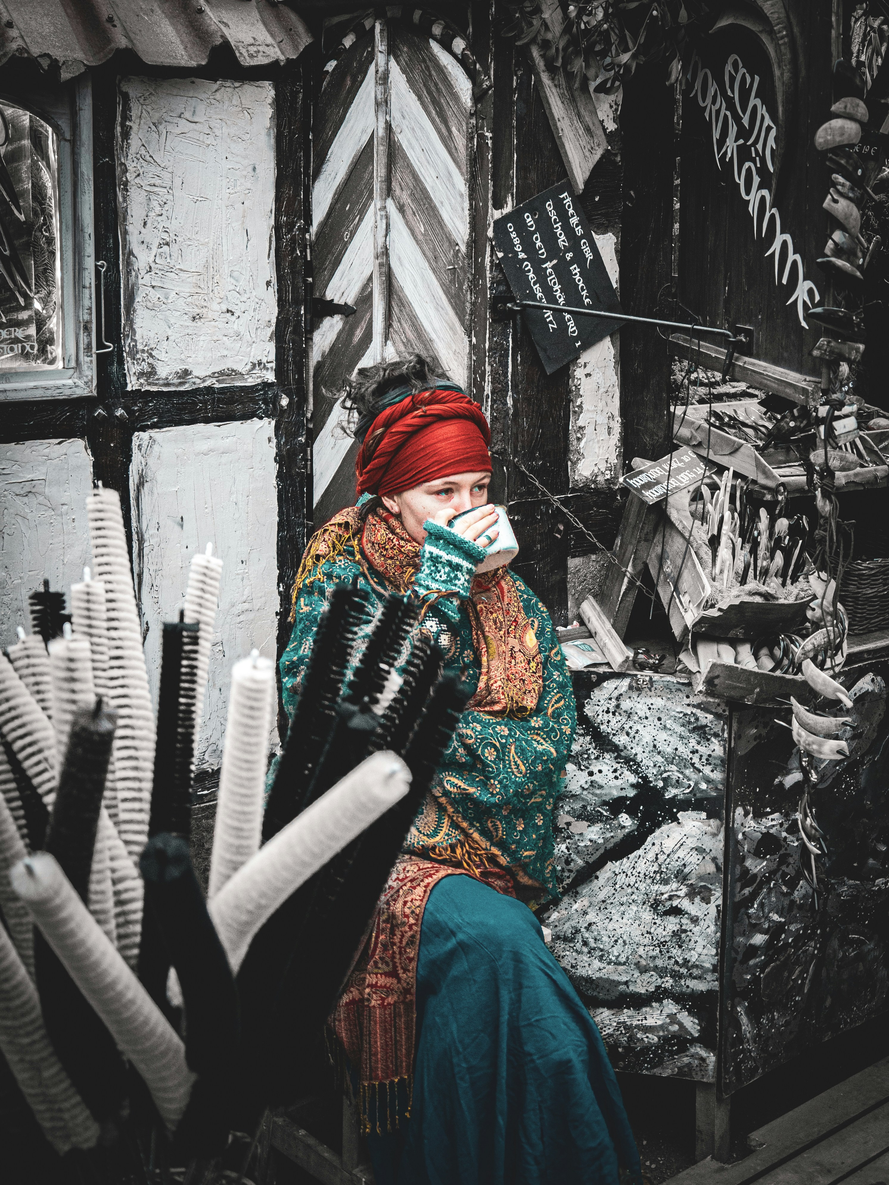 Woman in colorful clothing drinks from cup