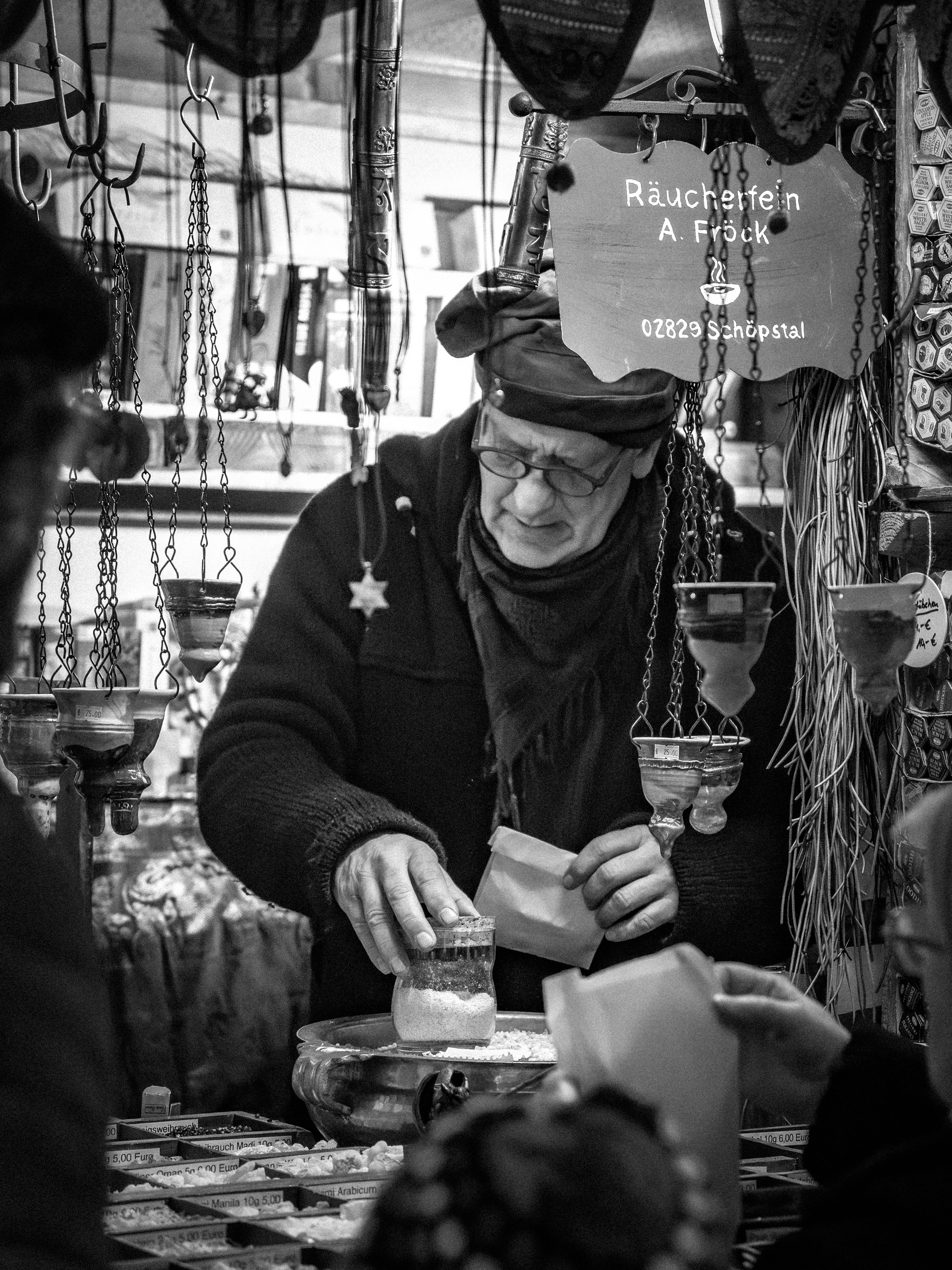 Man selling incense at a market stall
