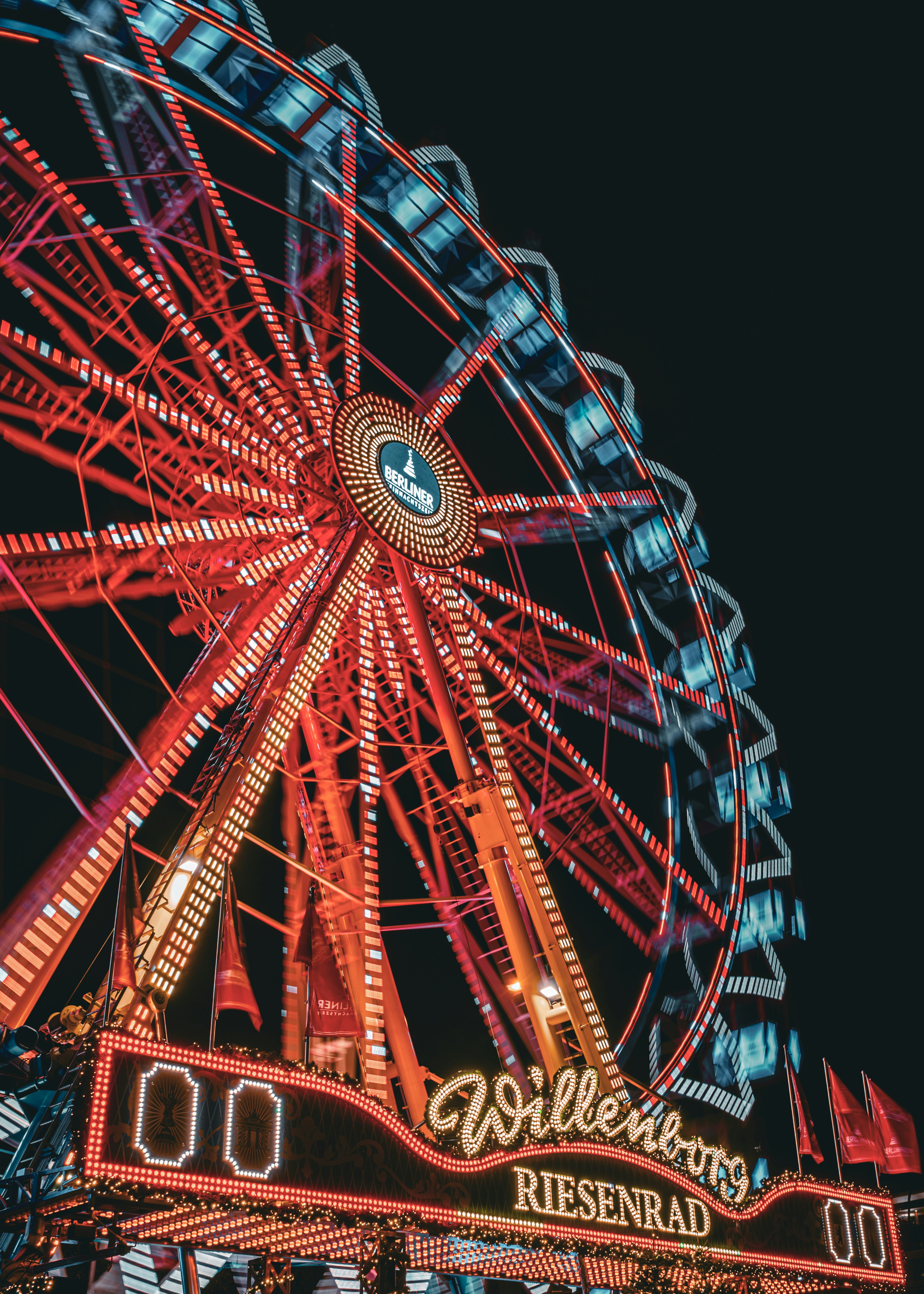 A brightly lit ferris wheel at night
