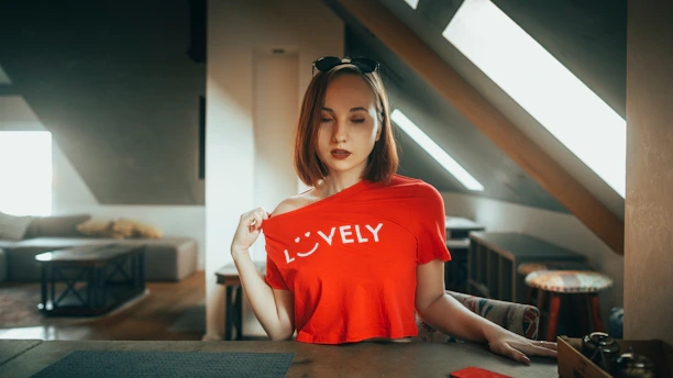 Woman in red shirt with 'lovely' text