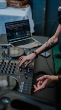 Dj mixing music on turntable with laptop