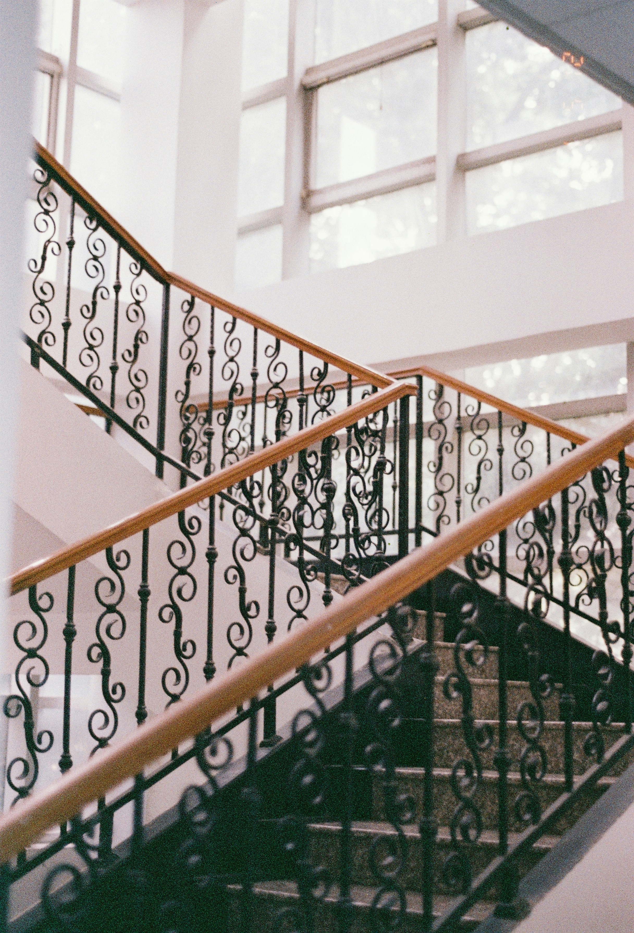 Ornate metal railings on a wooden staircase