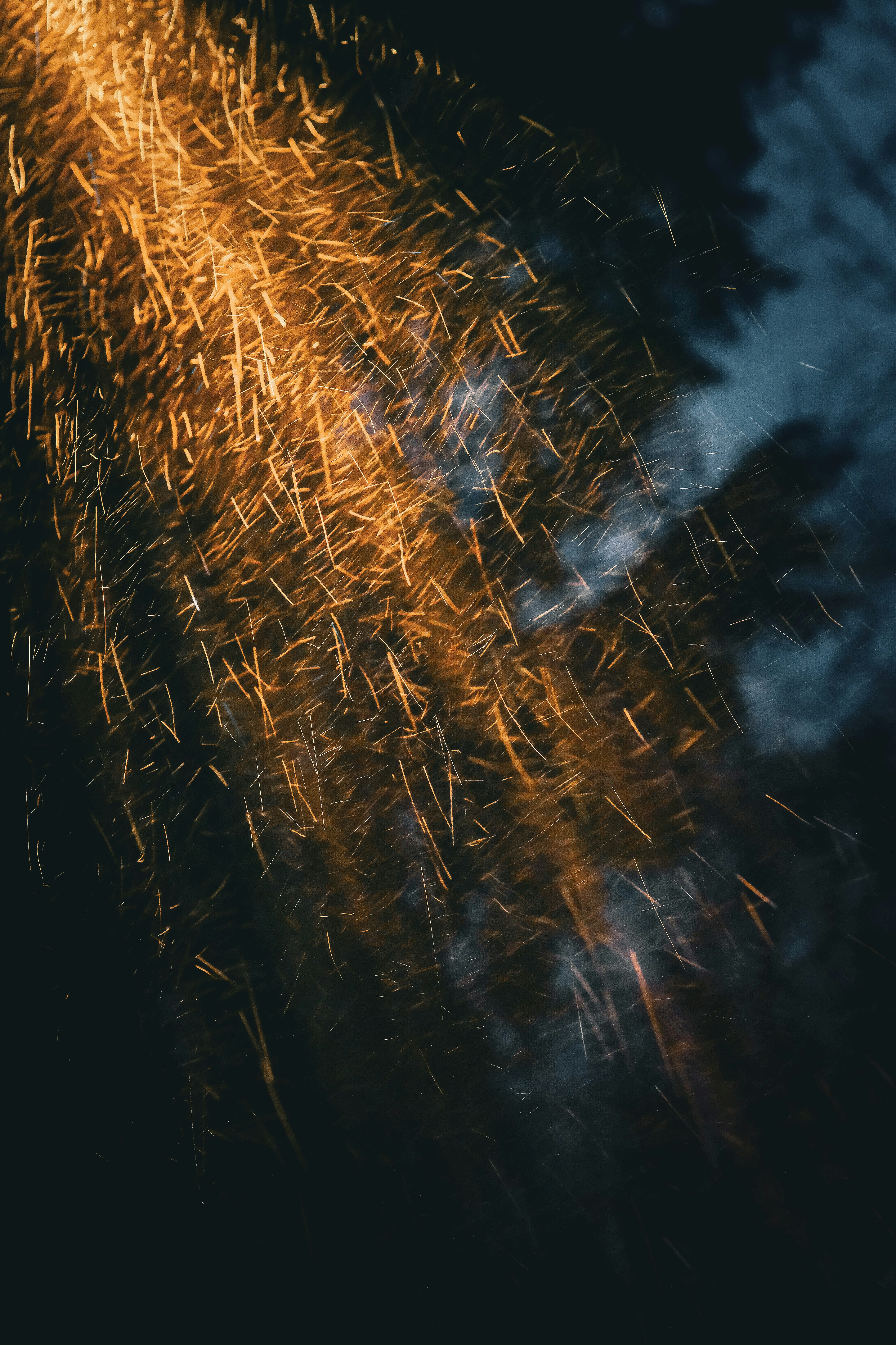 Scintille dorate attraversano un cielo scuro e nuvoloso.