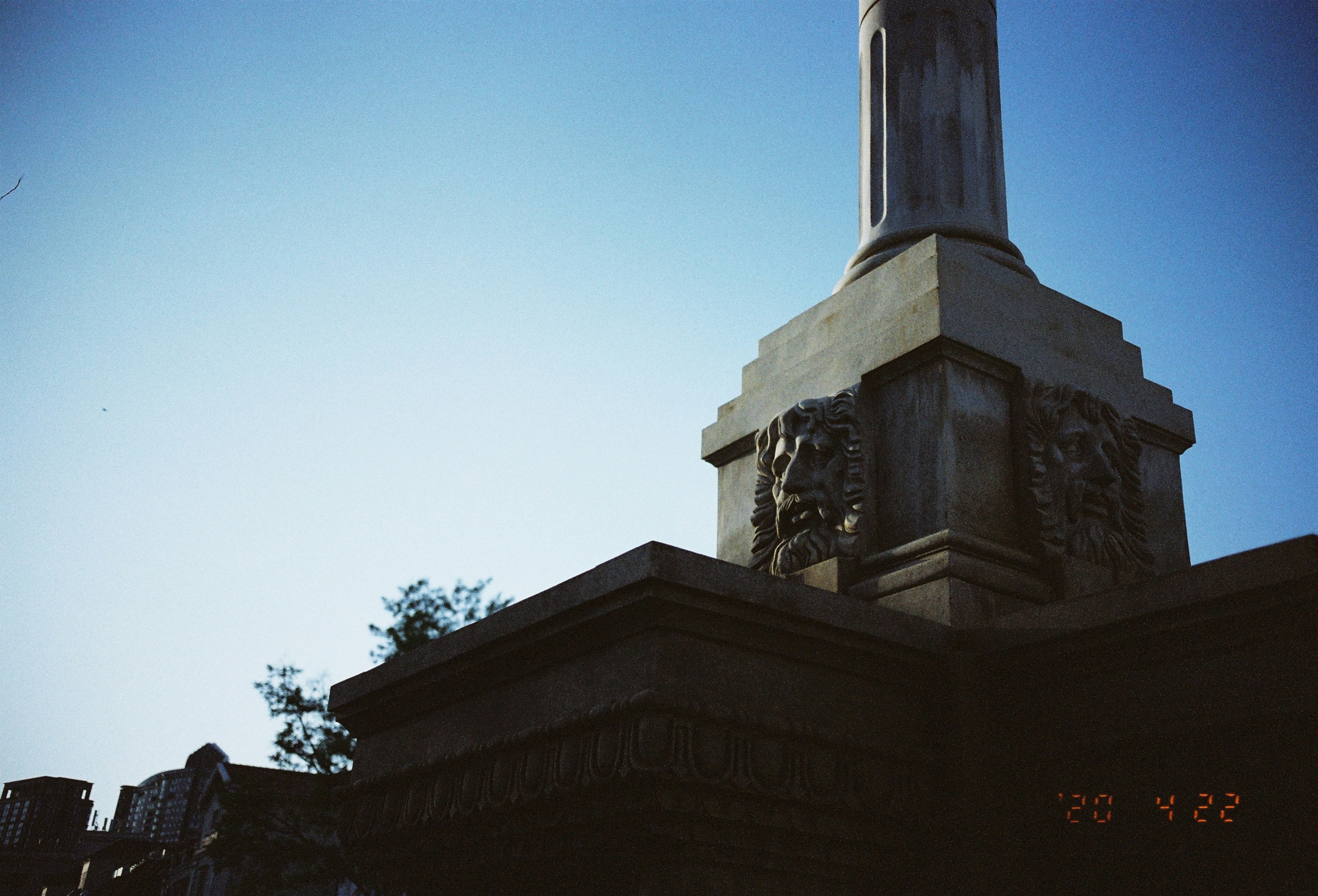 Stone monument with carvings against a clear blue sky