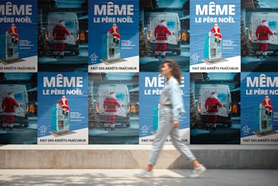 Woman walks past posters of santa claus