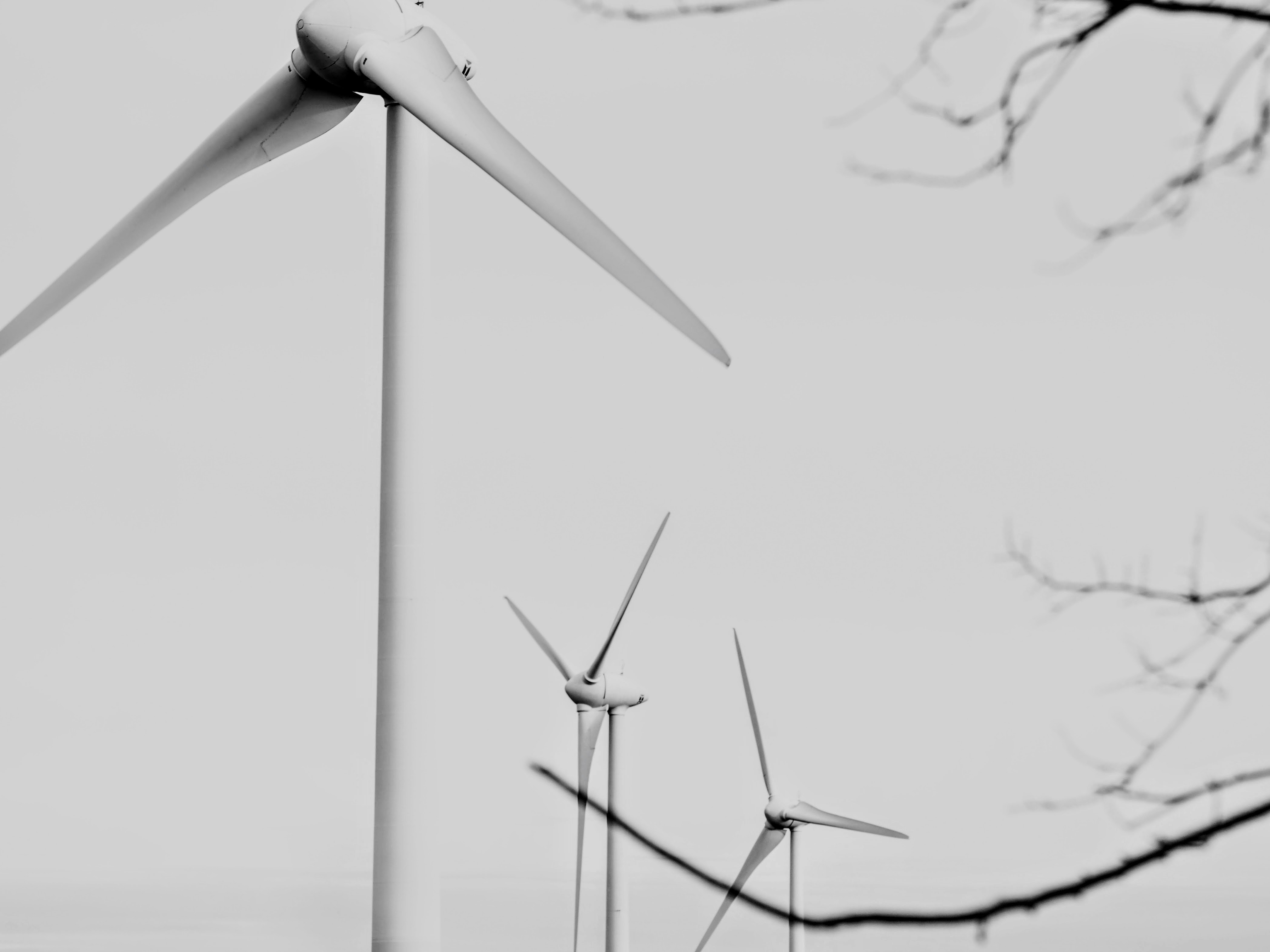 Wind turbines against a bright sky