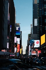 Times square with bright billboards and traffic at dusk