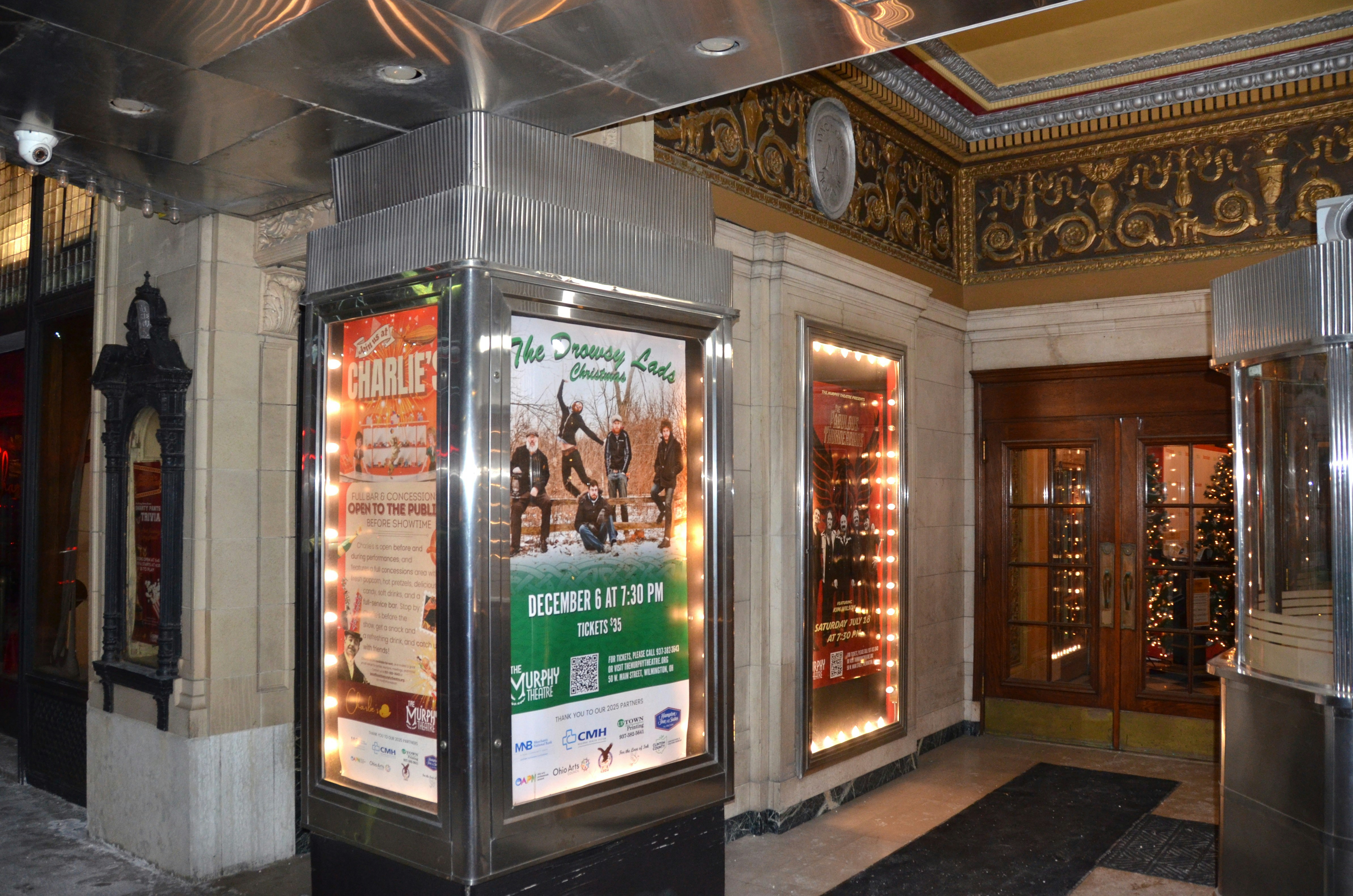 Marquee entrance with posters and ornate decor