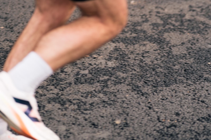 Runner's legs in motion on pavement