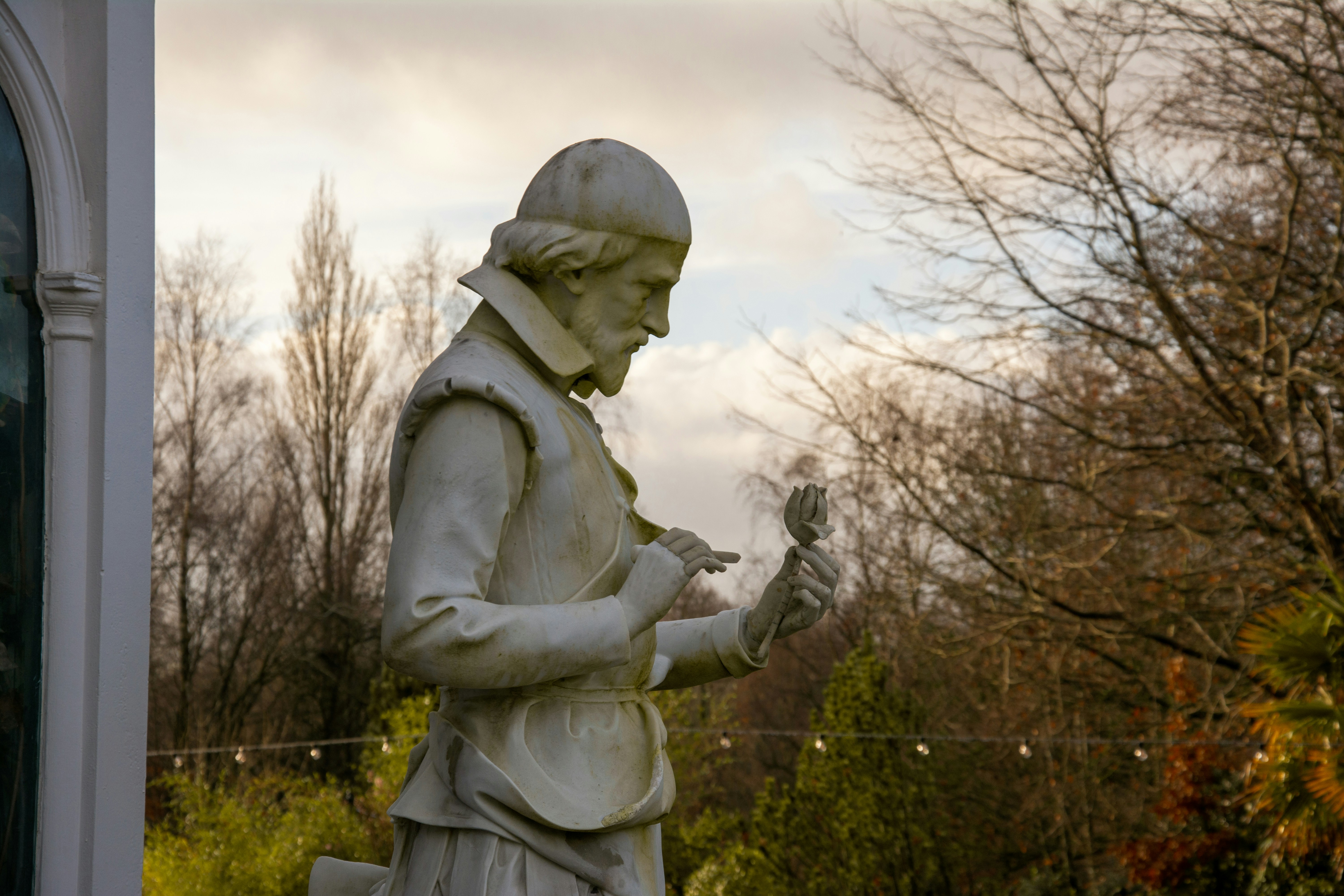 Stone statue of a man holding a small object