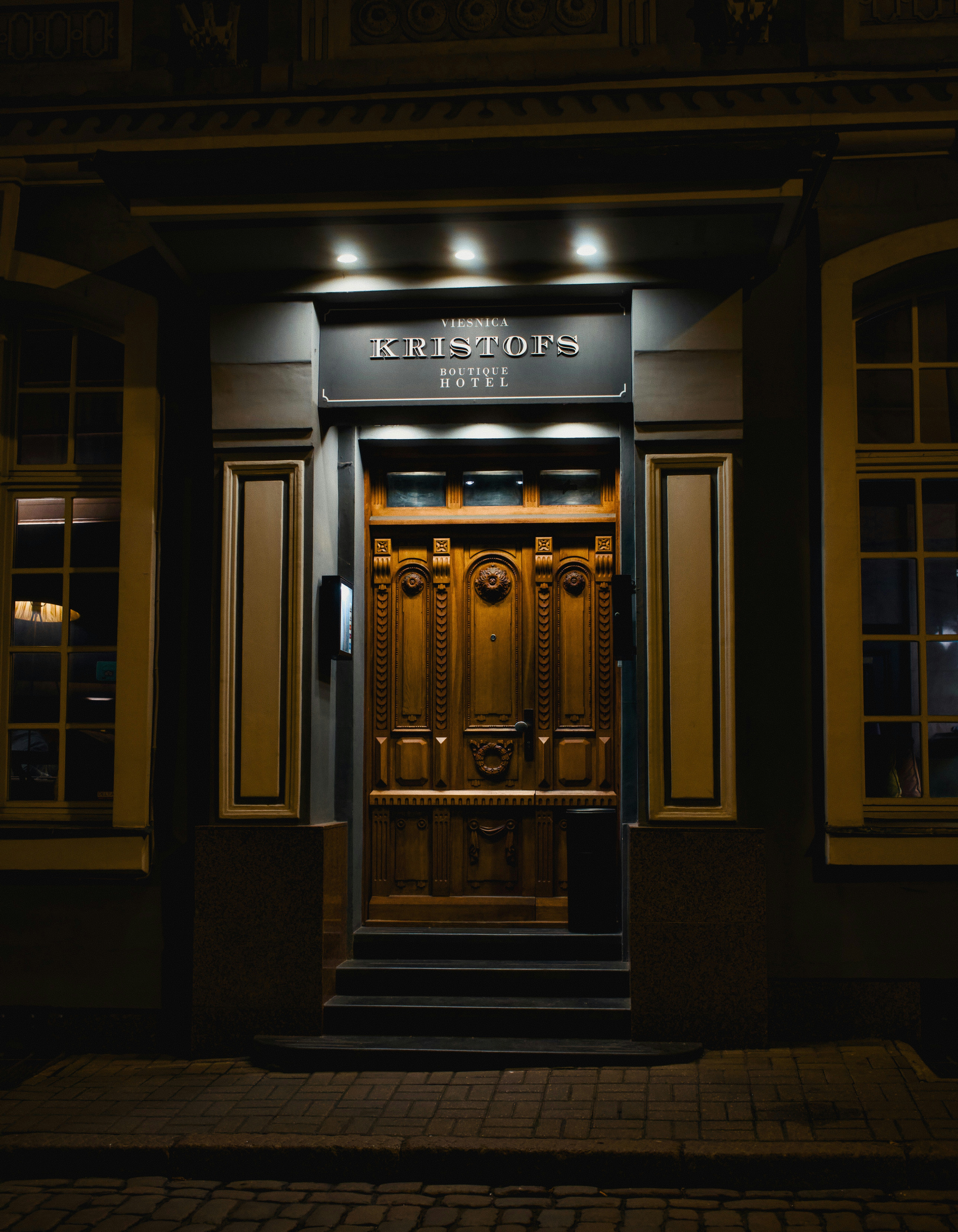 Ornate wooden hotel entrance at night