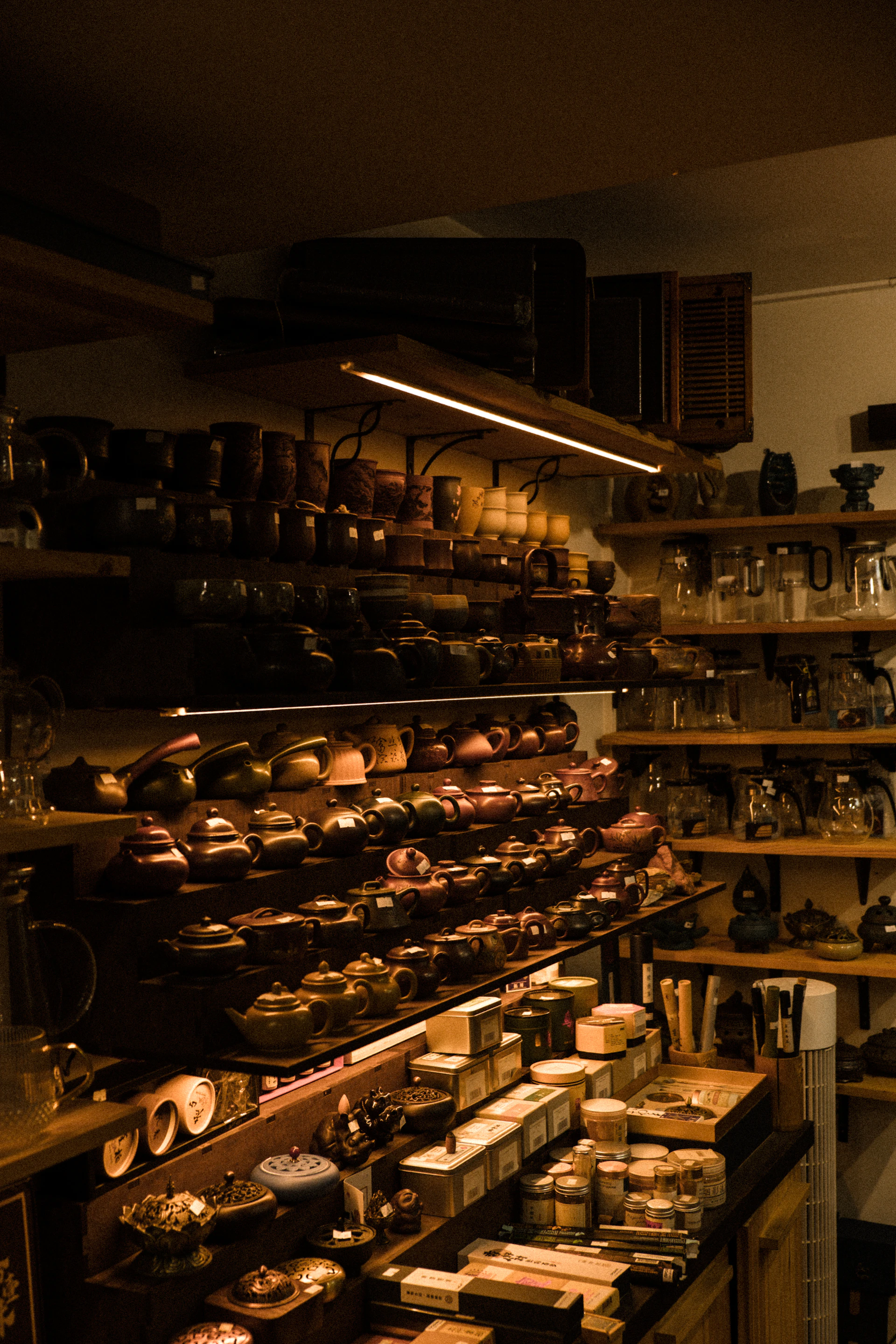Shelves filled with teapots, cups, and tea accessories.