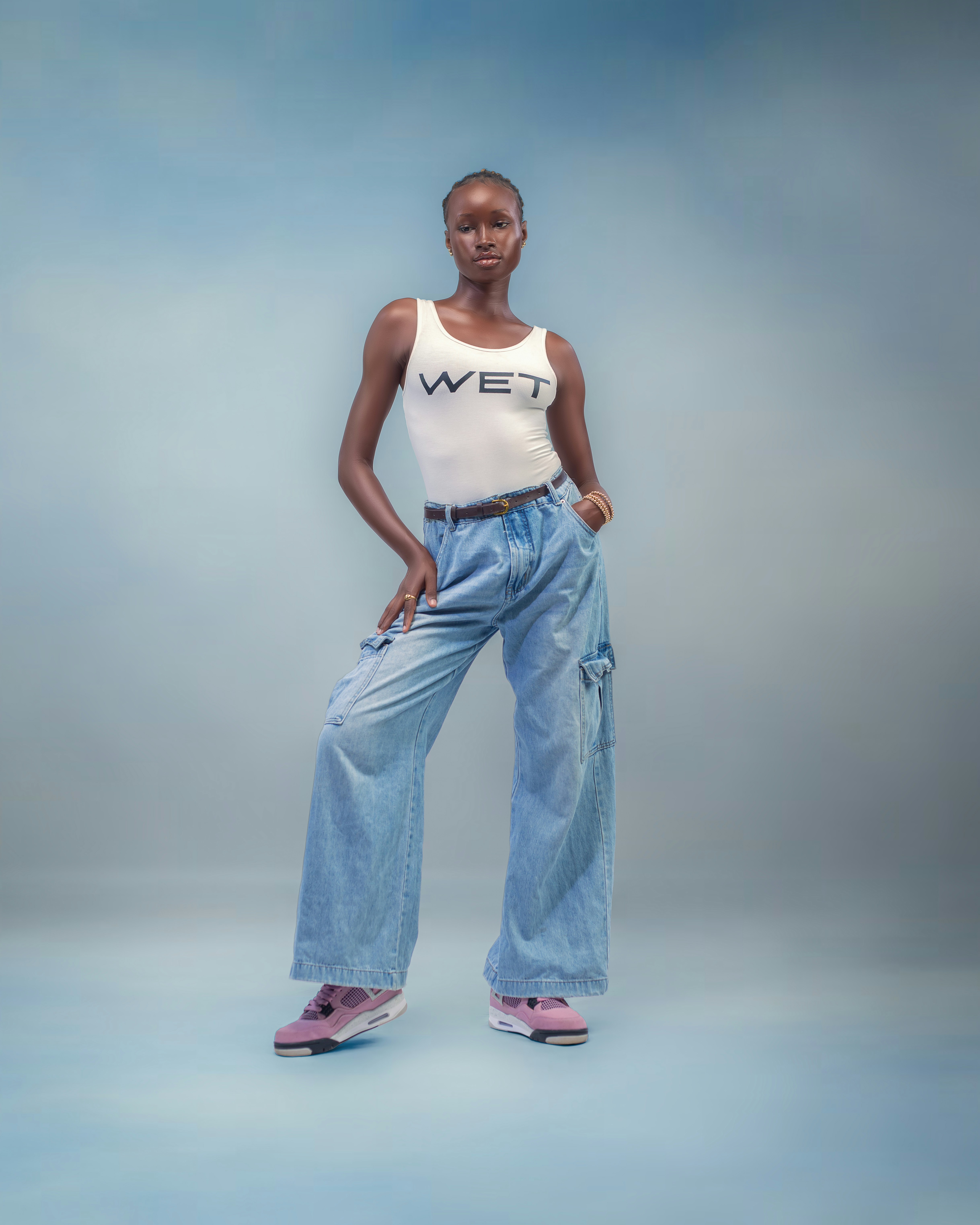 Wanita dengan tank top dan jeans longgar