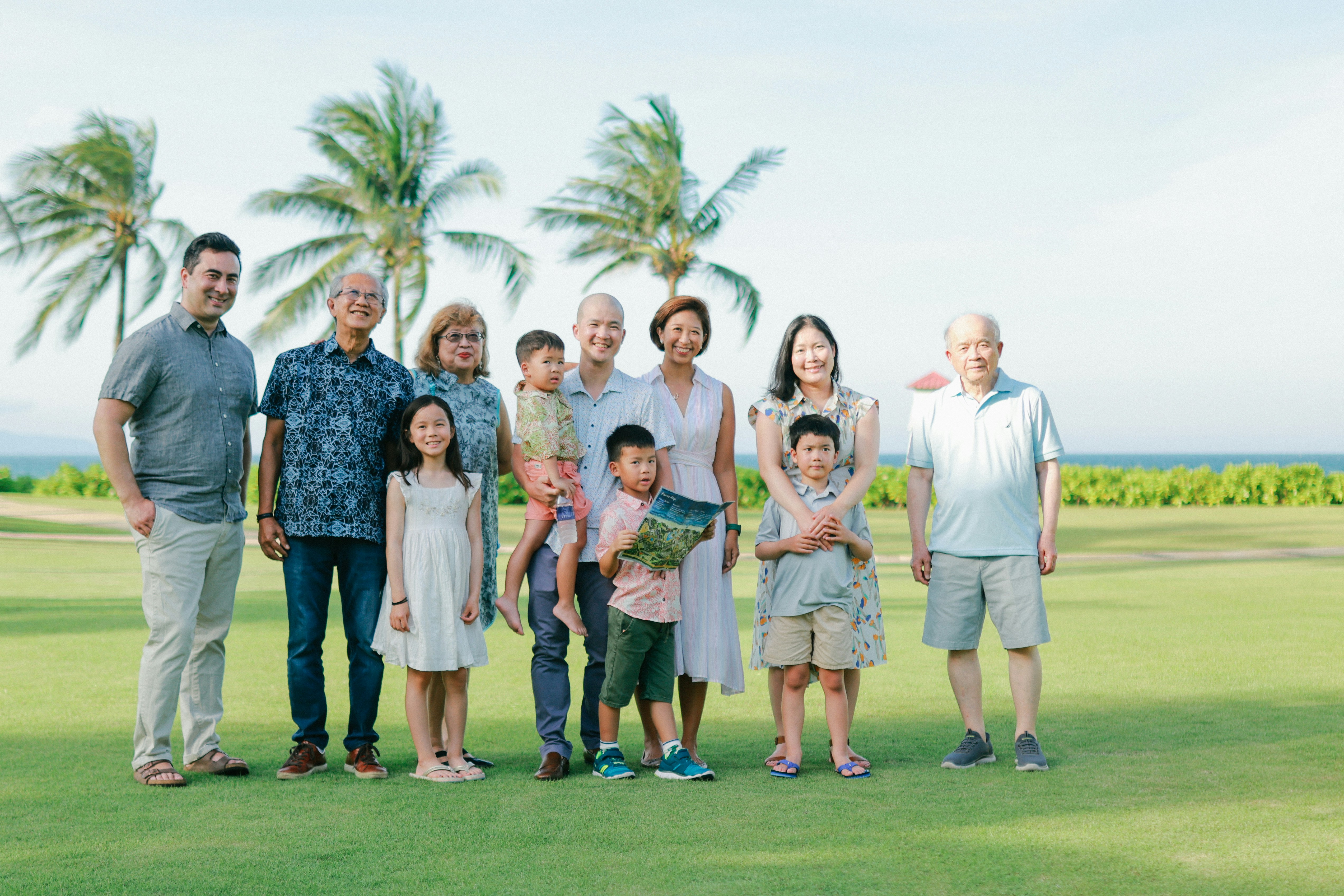 A large family posing for a group portrait outdoors.