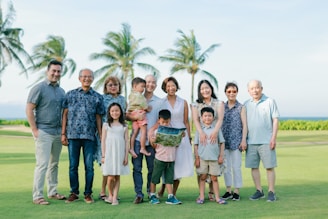 A large family poses for a group portrait outdoors.