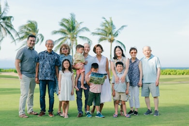 A large family poses for a group portrait outdoors.