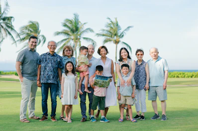 A large family poses for a group portrait outdoors.