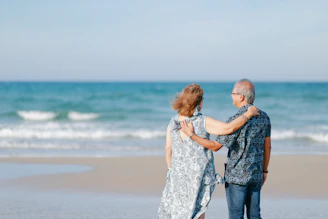 Elderly couple embracing on a beach