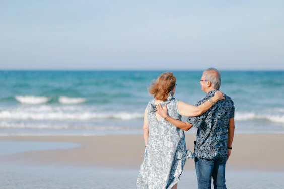 Elderly couple embracing on a beach